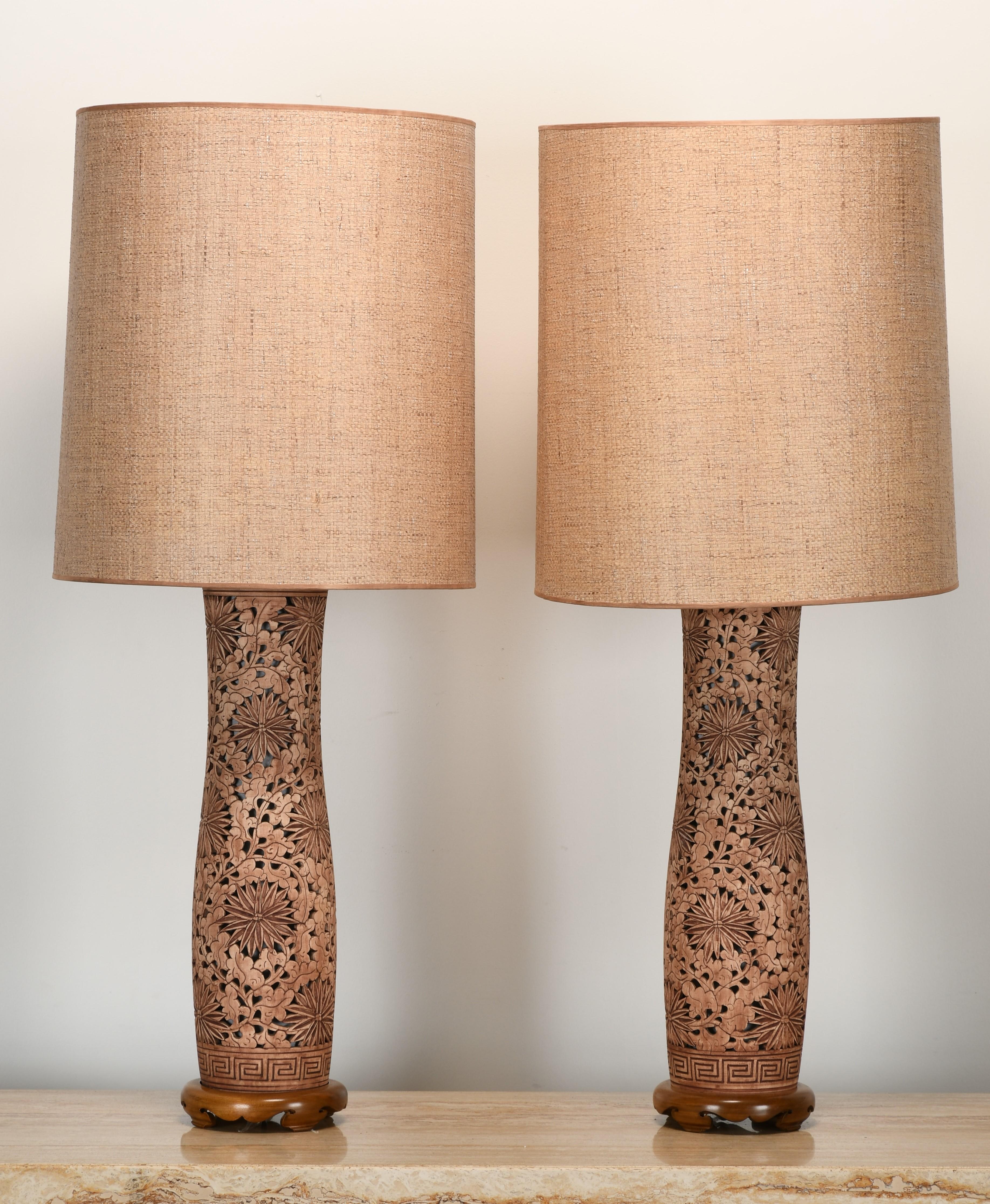 An organic modern pair of Asian table lamps that make a statement. These lamps are stunning with their reticulated body and burlap natural frame lamp shade. Possibly Japanese or Asian origin. The beautifully lit base accentuates the design. Shades
