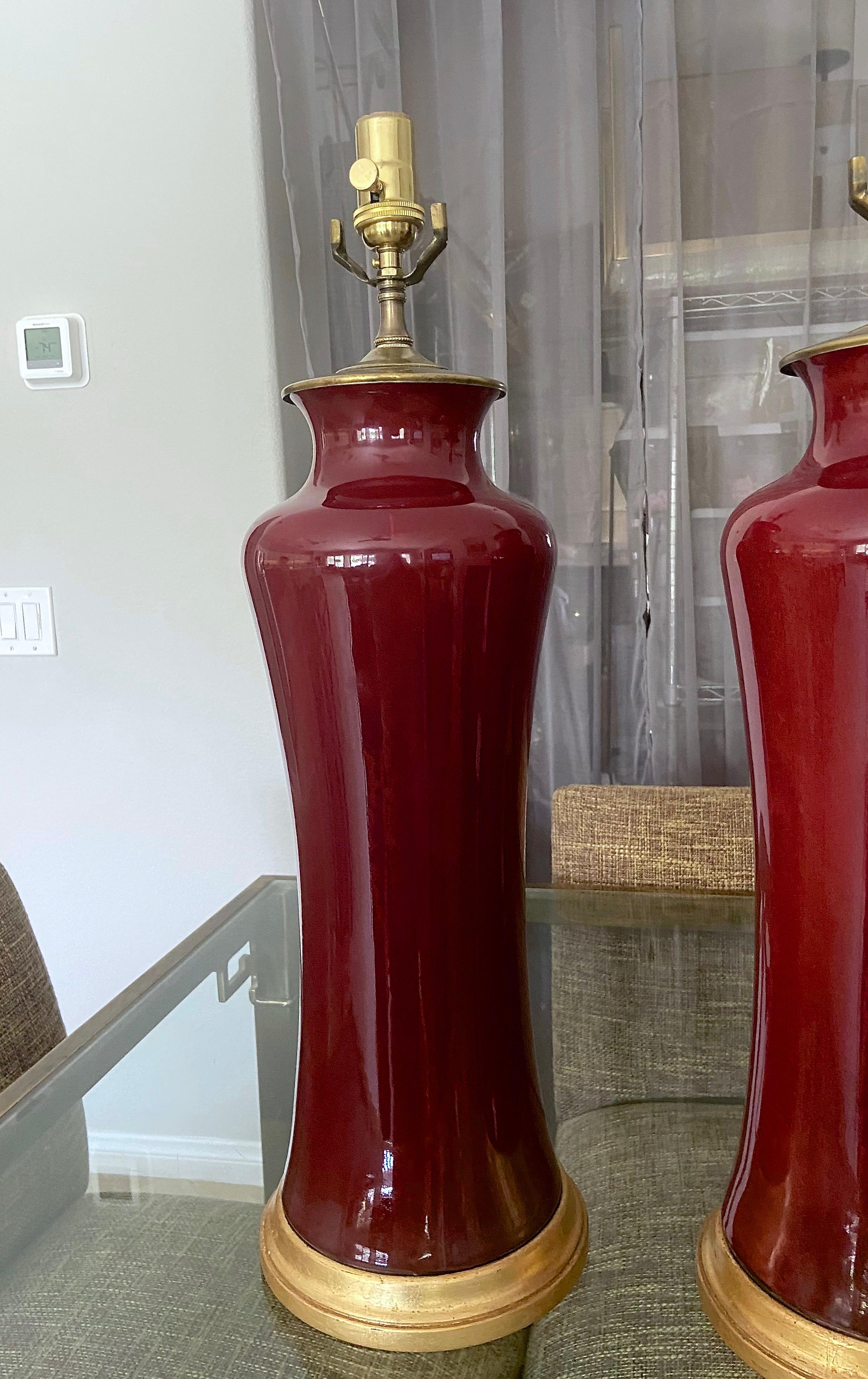 Giltwood Pair of Asian Oxblood Porcelain Lamps