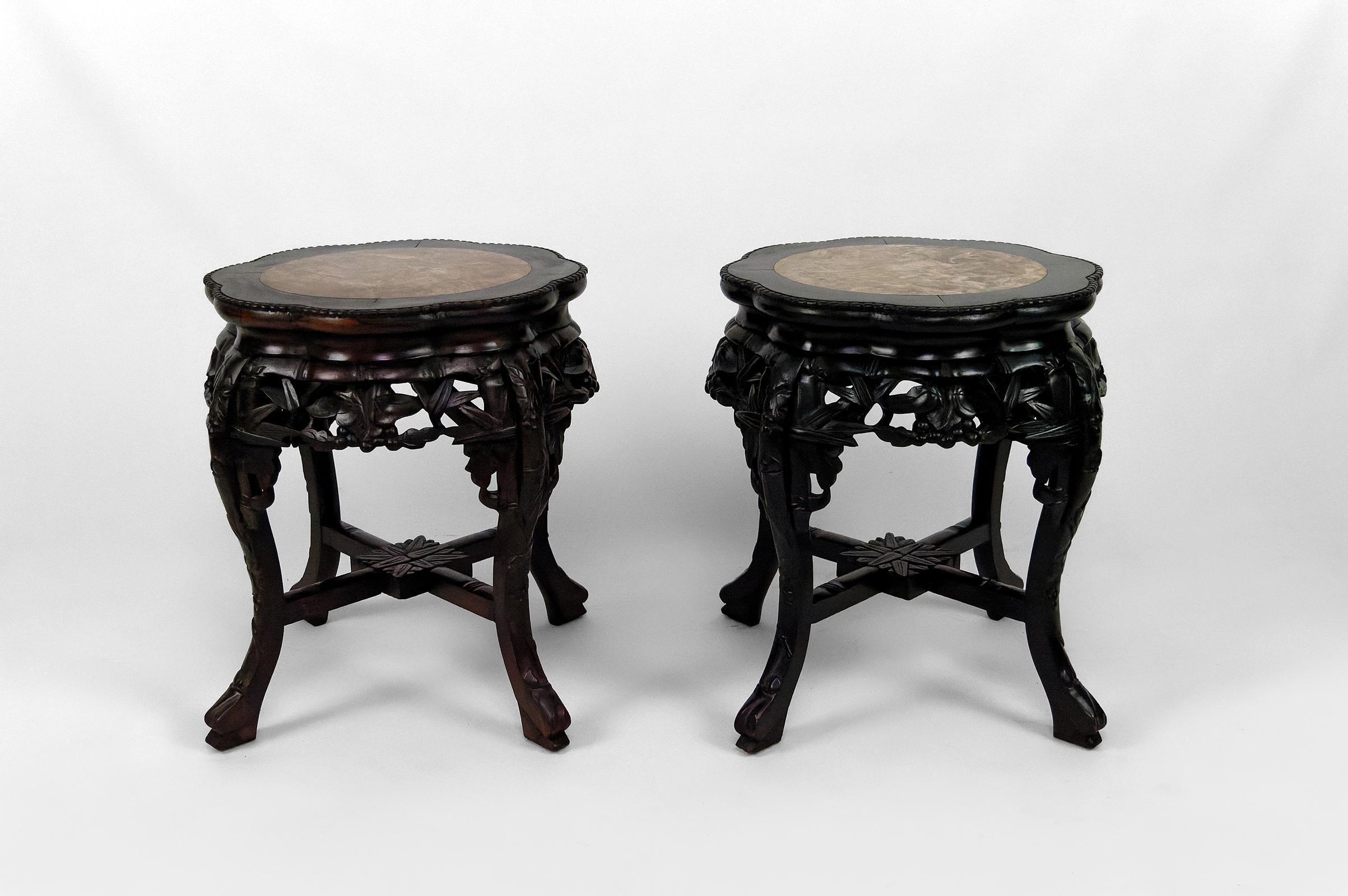 Superb pair of side tables / stools / pedestal tables/ plant holders / pot holders in carved solid wood.

The sculptures represent floral motifs and berries.
The top is in marble, borders decorated with sculpted pearls.

Asia, South China or former