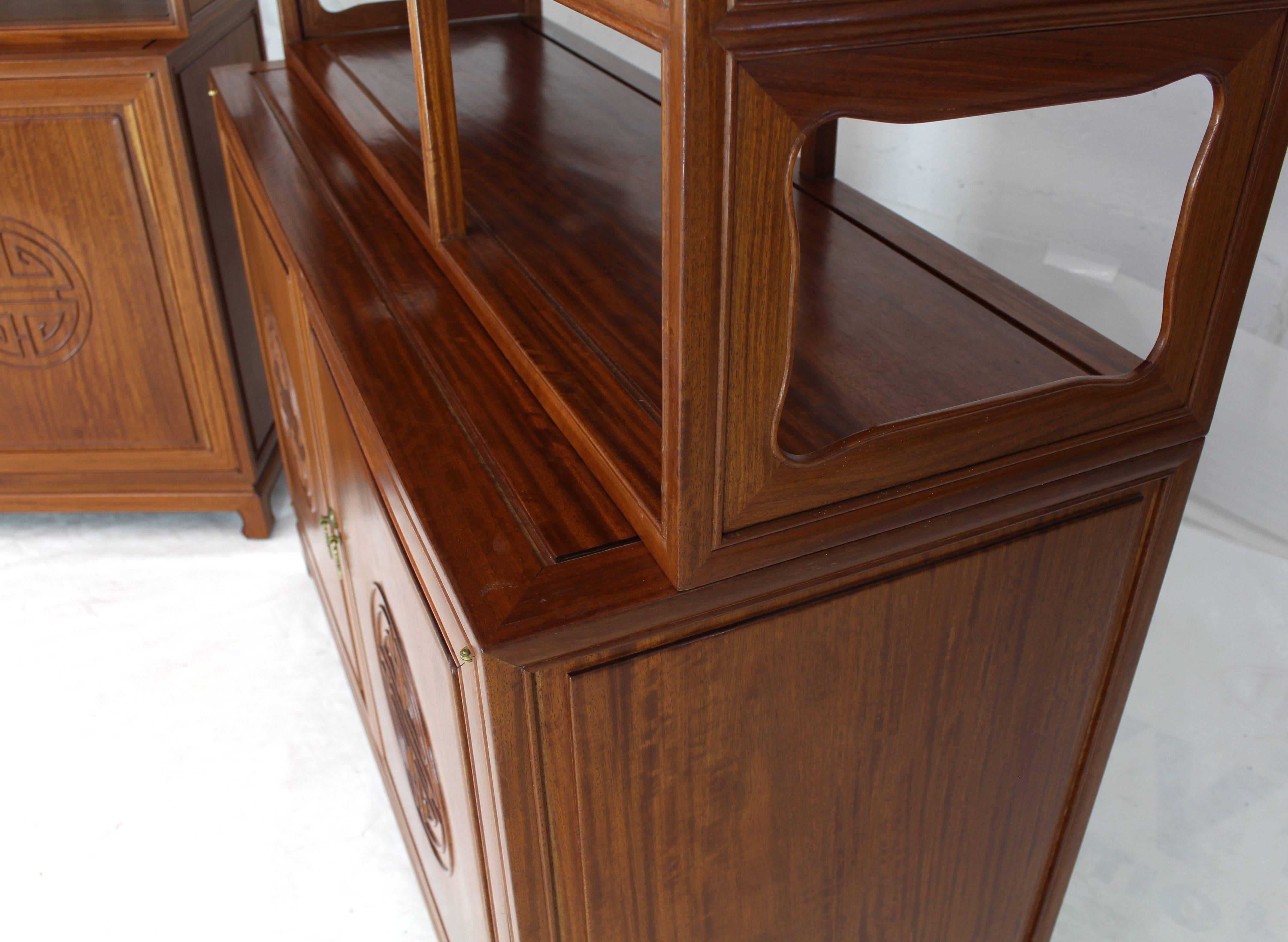 Pair of decorative solid teak carved étagères bookcases shelves with bottom cabinets. Asian inspired. Solid brass pulls.