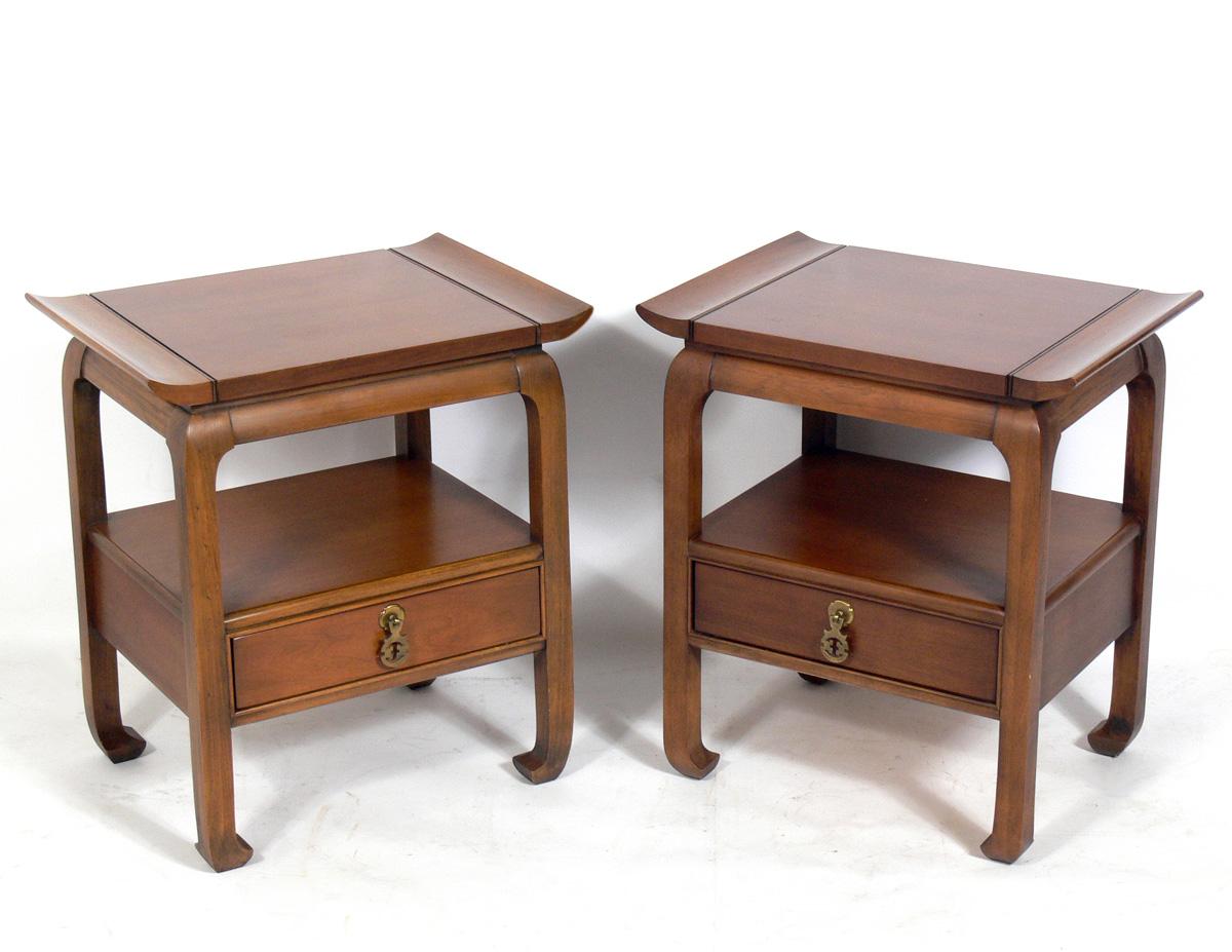 Pair of Asian style end tables or nightstands, American, circa 1950s. These pieces are currently being refinished and can be completed in your choice of color. The price noted includes refinishing in your choice of color. They would look great in a