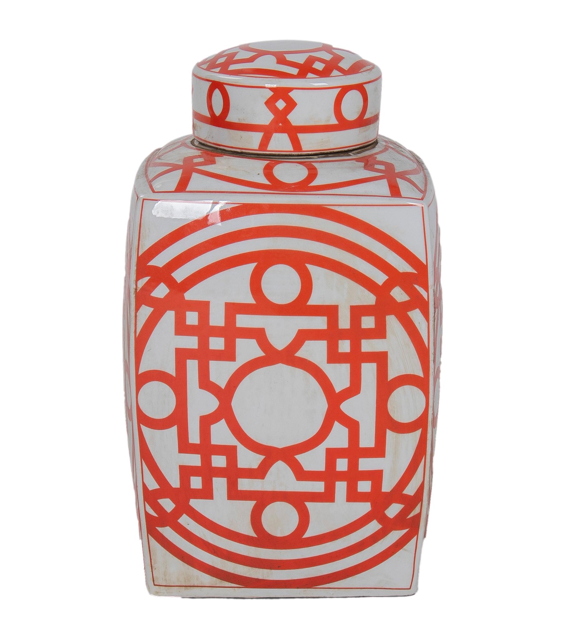 Pair of Asian white glazed porcelain urns with red geometric decorations and lids.