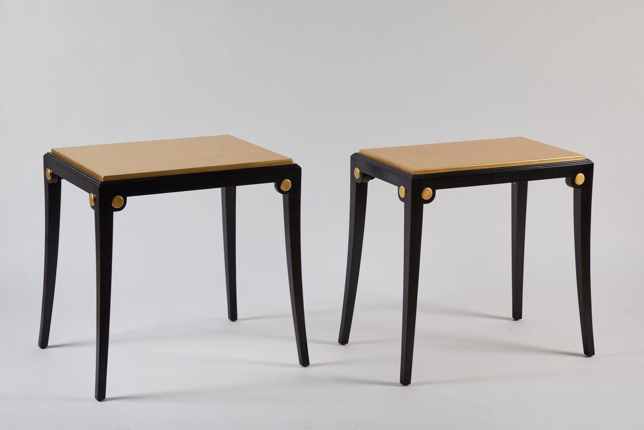 Pair of assembled custom tables. Ebonized maple frames with bead detail around top edge, splayed legs, gold leaf top and gold leaf round accent detail on each corner. These tables have a Classic feel but could be used in the most contemporary of