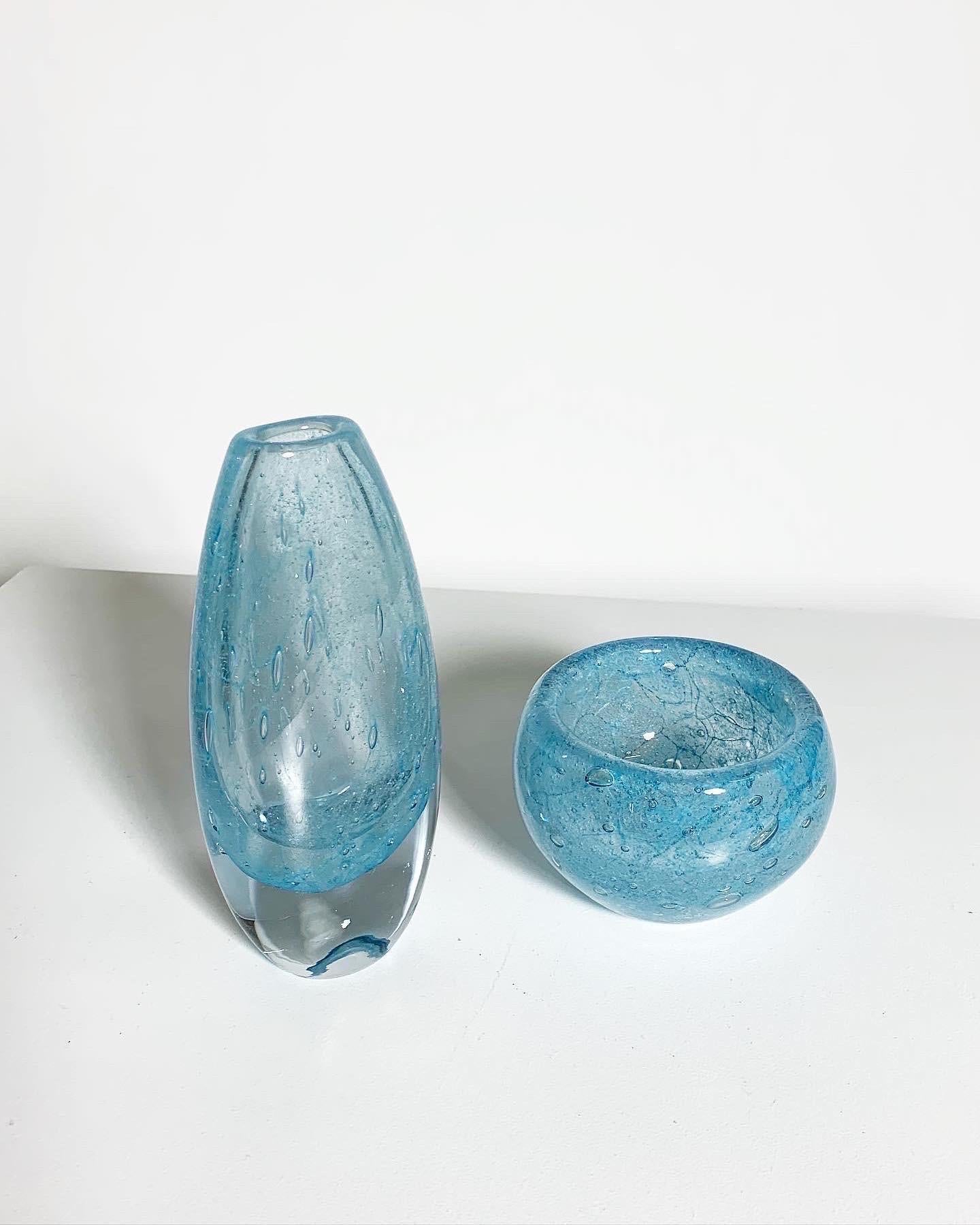 The shape of these two models were designed by Gunnar Nylund for Strömbergshyttan in Sweden, however the blue bubble technique was developed by Asta Strömberg and introduced by Strömbergshyttan in the early 1970s.

Vase
Height: 21.5 cm
Width: 9