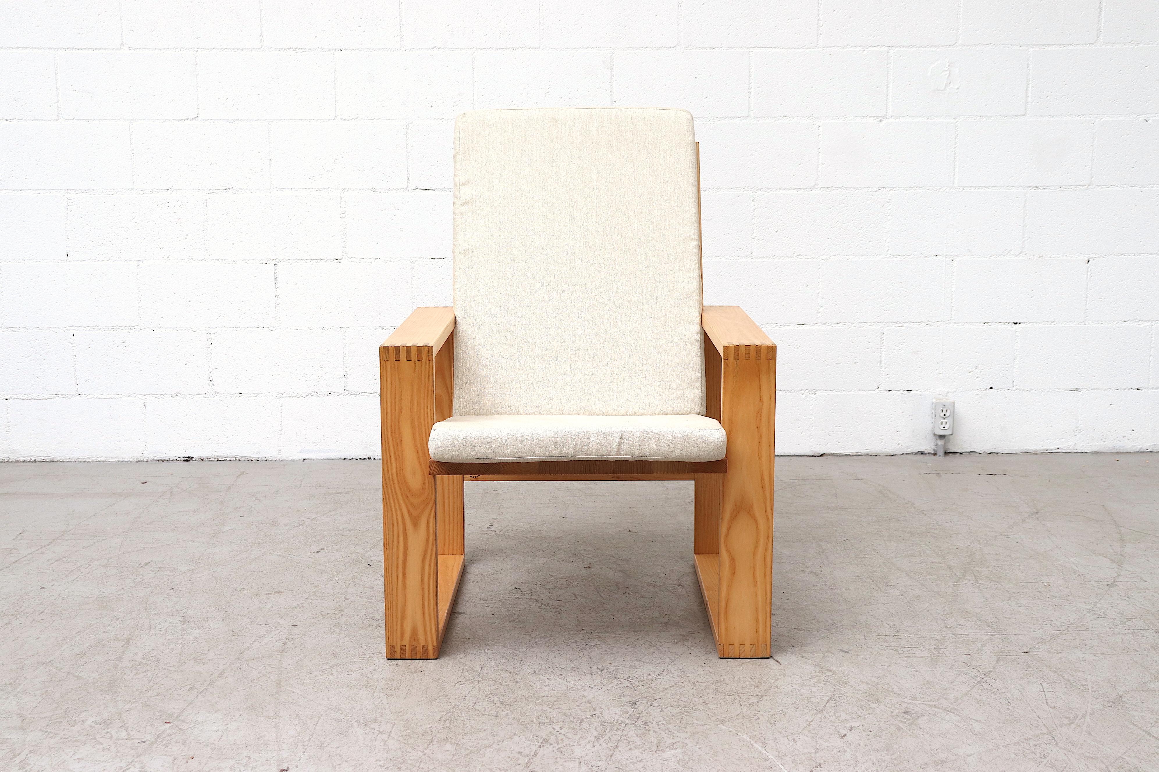 Great pair of pine Ate Van Apeldoorn high back lounge chairs with bone white upholstered cushions. Handsome square design. In good overall condition with visible wear to frame. Wear is consistent with their age and usage. Set price.