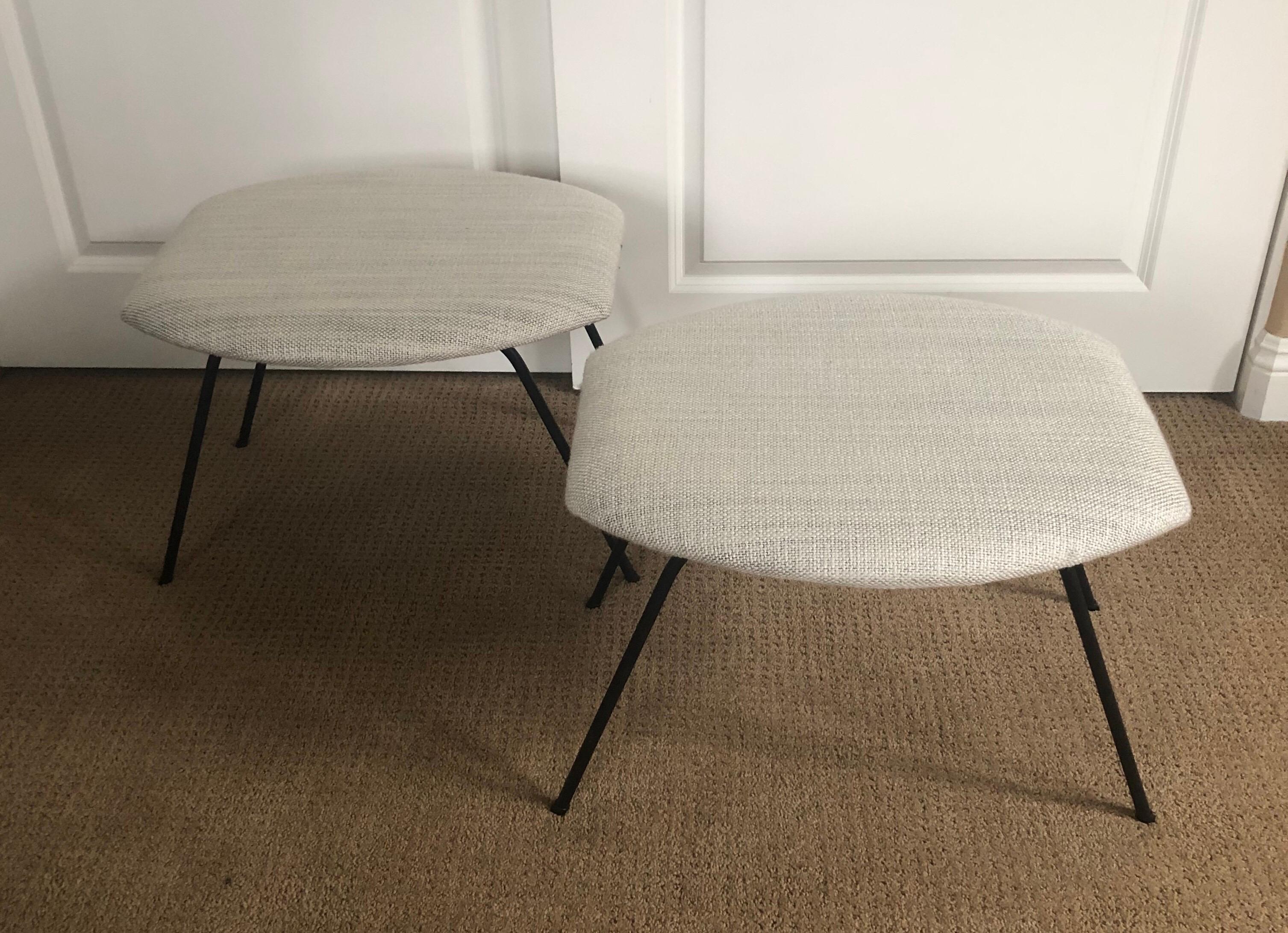 Pair of atomic age iron base ottomans / benches by Joseph Cicchelli, circa 1950s. - Great California design on this pair of freshly reupholstered ottomans with a cream linen fabric. The legs are solid iron pipping and have been resprayed in matte