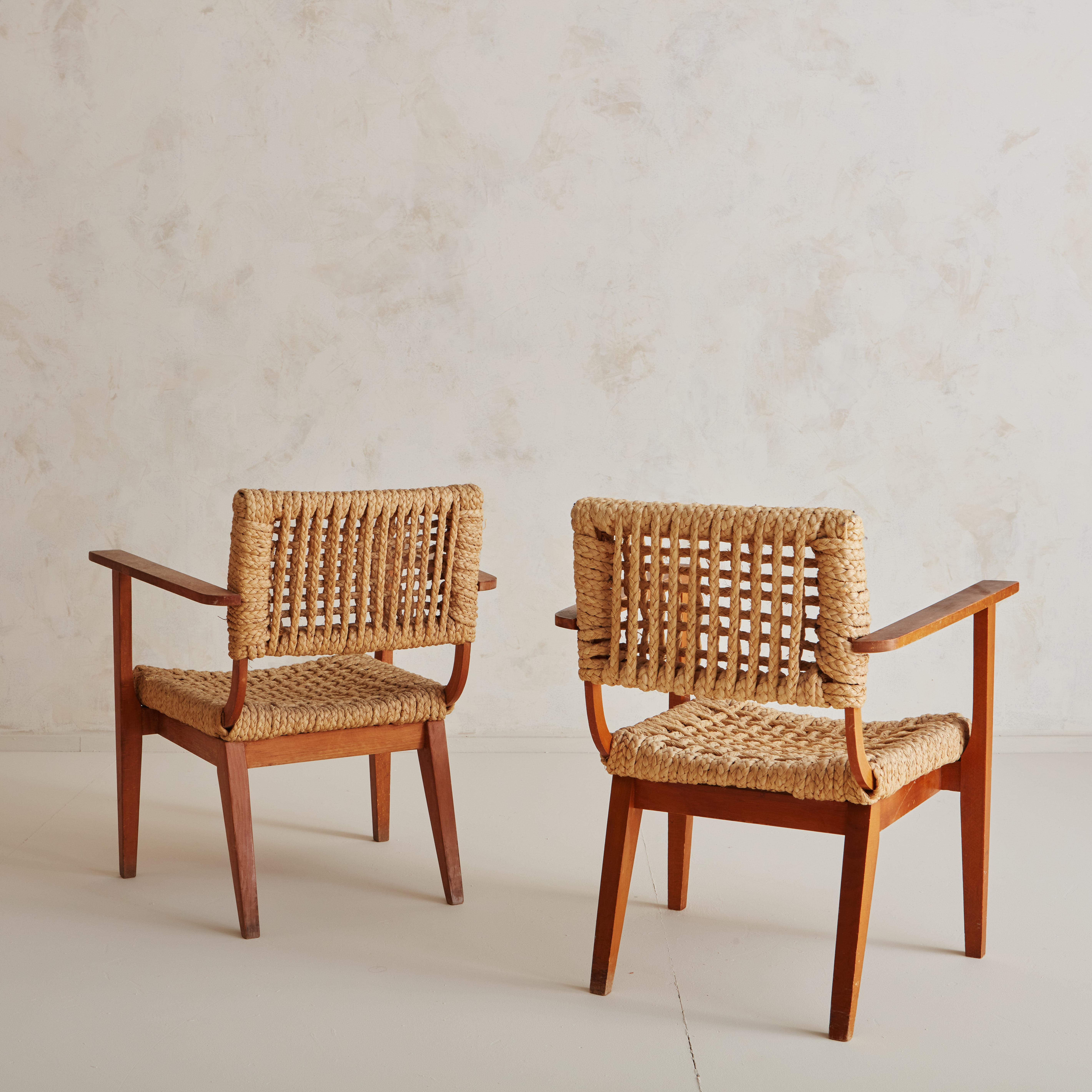 A stunning pair of 1950s rope and oak lounge chairs by renowned French Designers Adrien Audoux and Frida Minet.