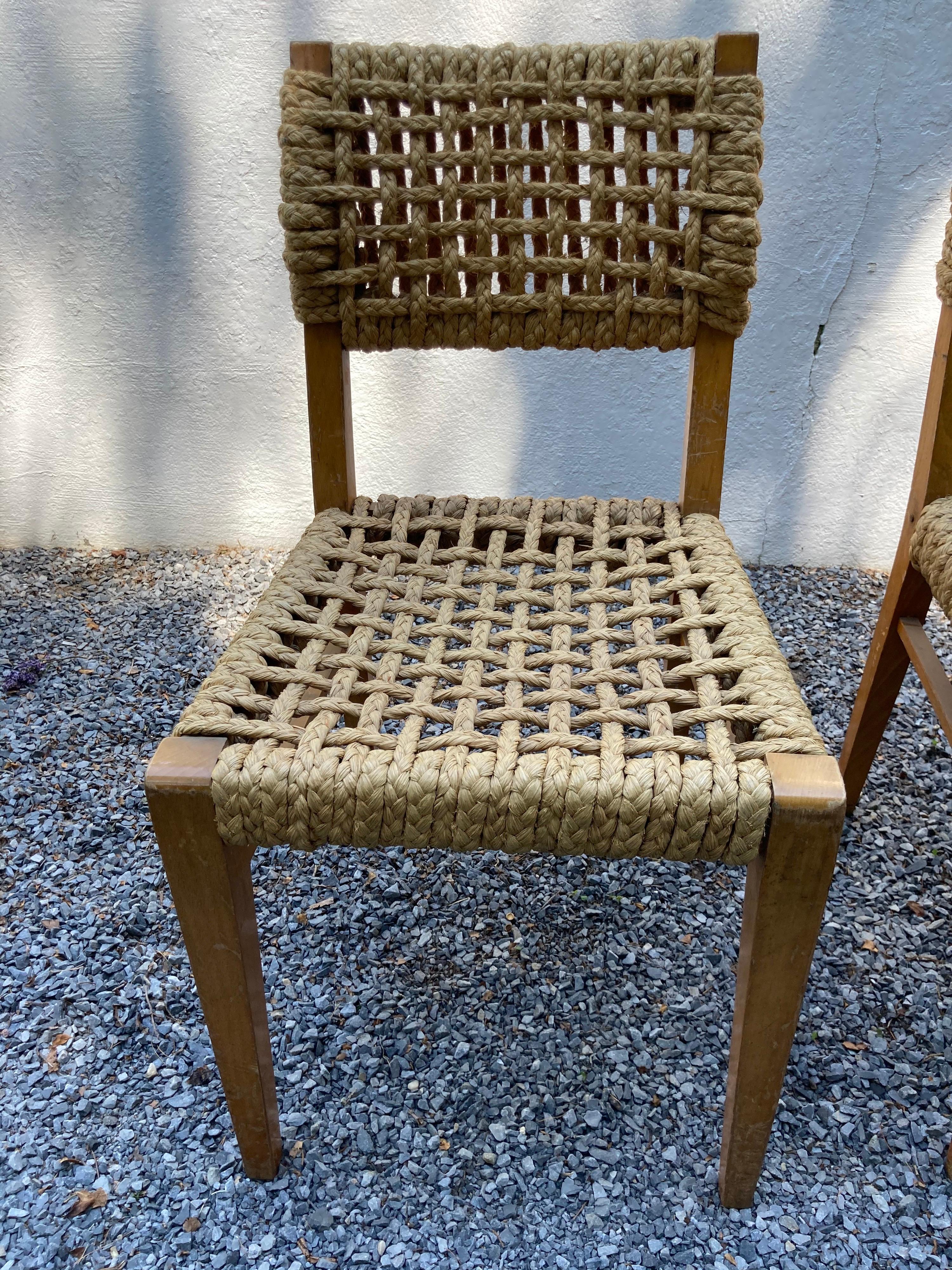 A pair of rope woven seats and backs dining or side chairs by the French designers Audoux and Minet.