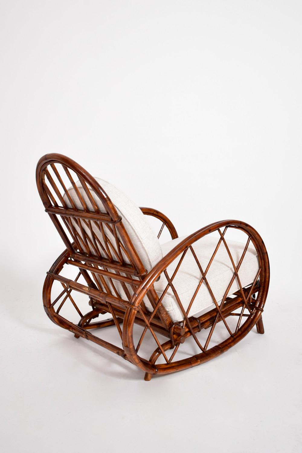 Pair of reclinable brown rattan armchairs, Audoux Minnet. France, 1950s.