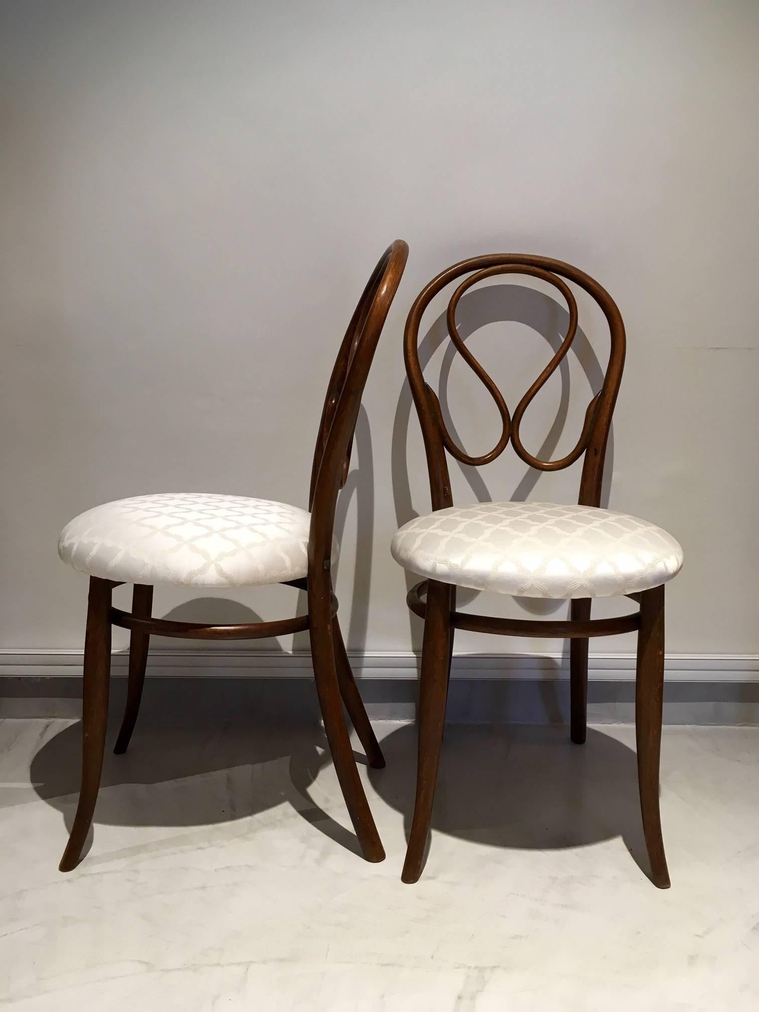 Bentwood chairs with new silk-blend seat upholstery. Chairs designed by August Thonet, the son of original bentwood furniture designer Michael Thonet. August took over his father's business in 1869.