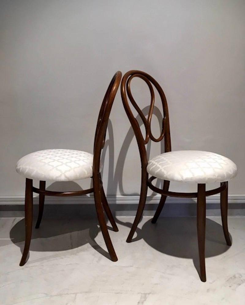 Bentwood chairs with new silk-blend seat upholstery. Chairs designed by August Thonet, the son of original bentwood furniture designer Michael Thonet. August took over his father's business in 1869.