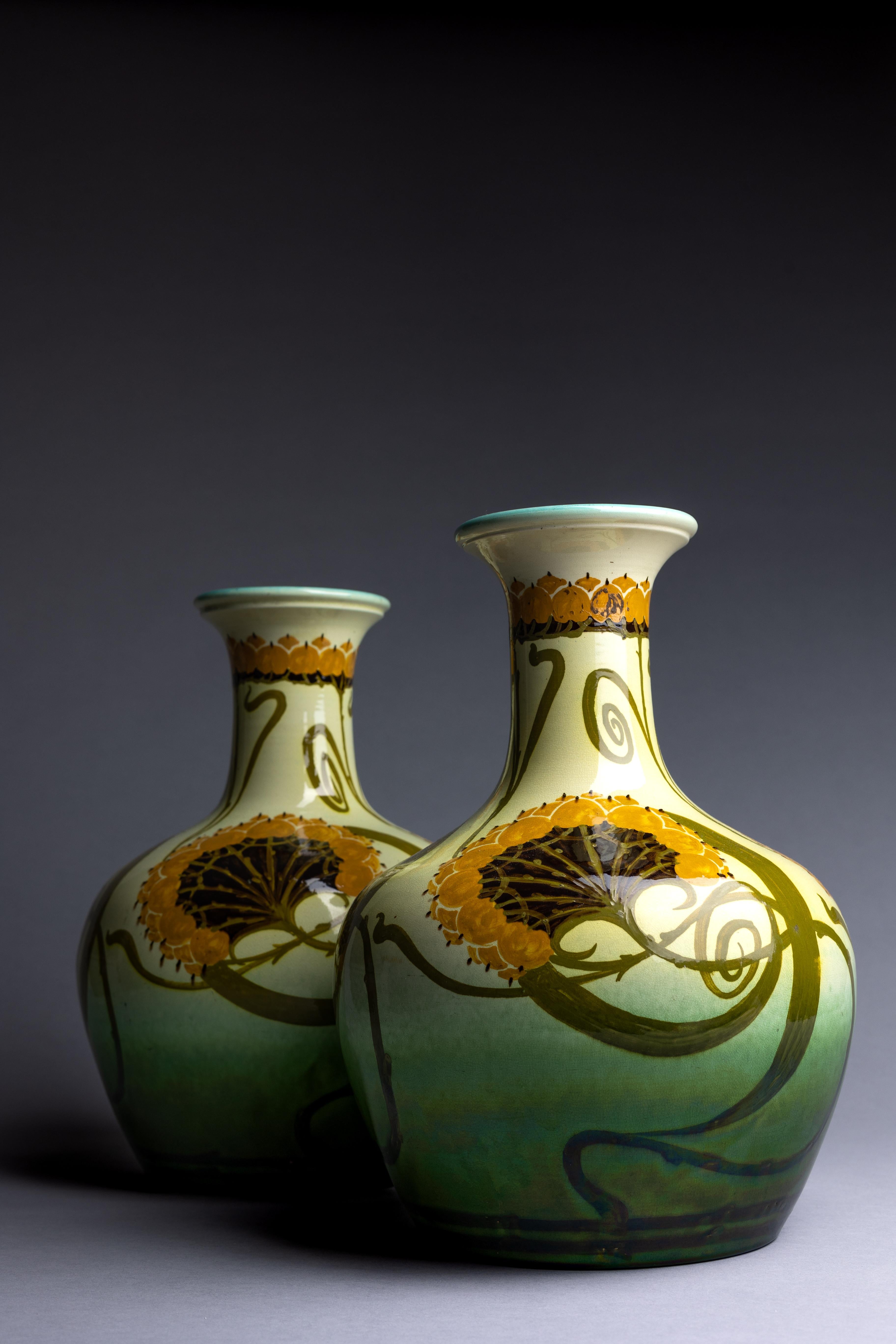 A pair of large Arts & Crafts vases hand-painted by Clarissa Ault circa 1890.

This pair of Arts & Crafts pottery vases were hand-painted by Clarissa Ault, daughter of English ceramicist William Ault and encompass a variety of styles from the late