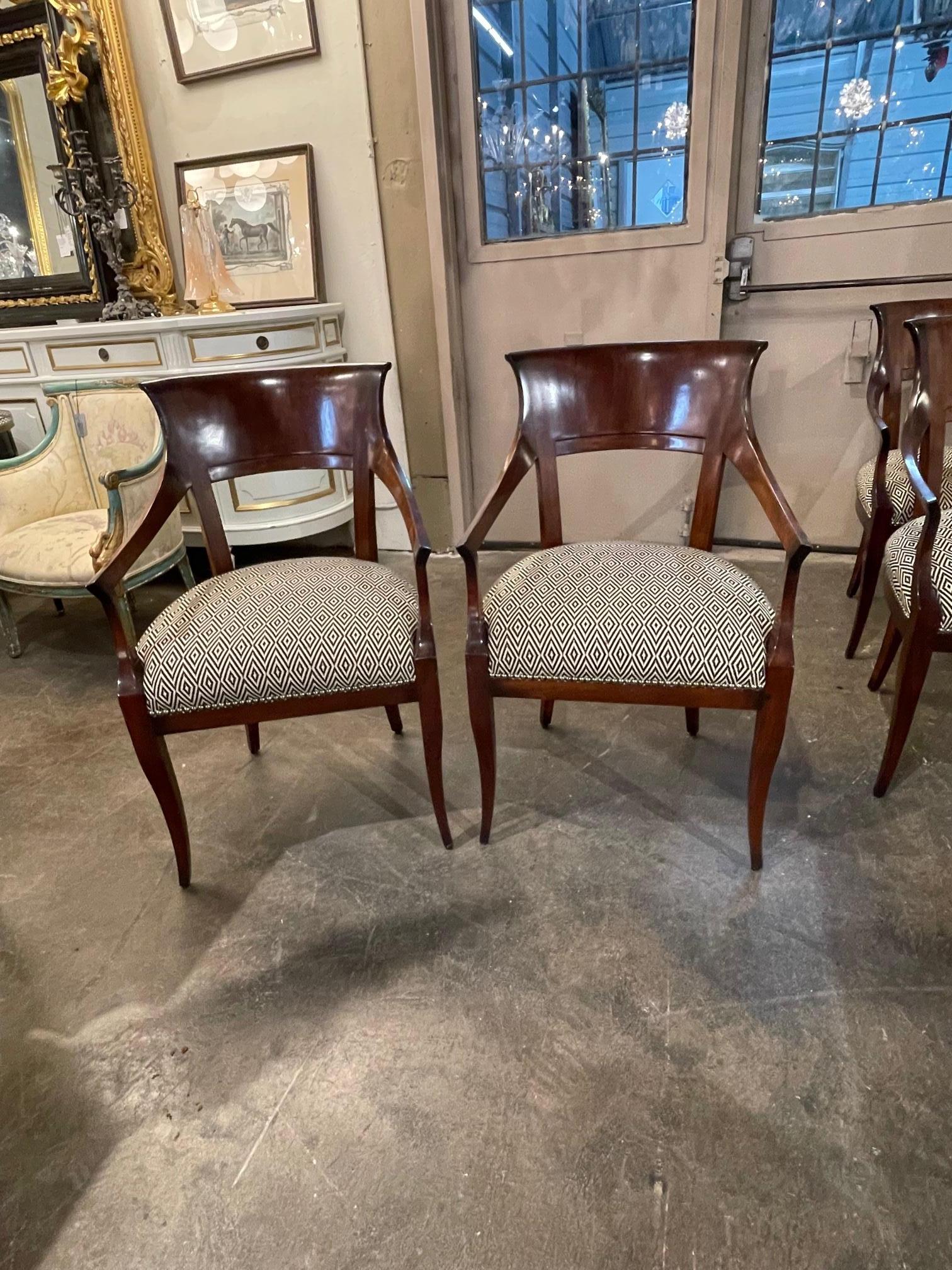 Pair of Austrian Biedermeier arm chairs Circa 1860. Beautiful hobnail detailing on the seat cushion. Gorgeous flame mahogany wood and finish. 2 pair available.