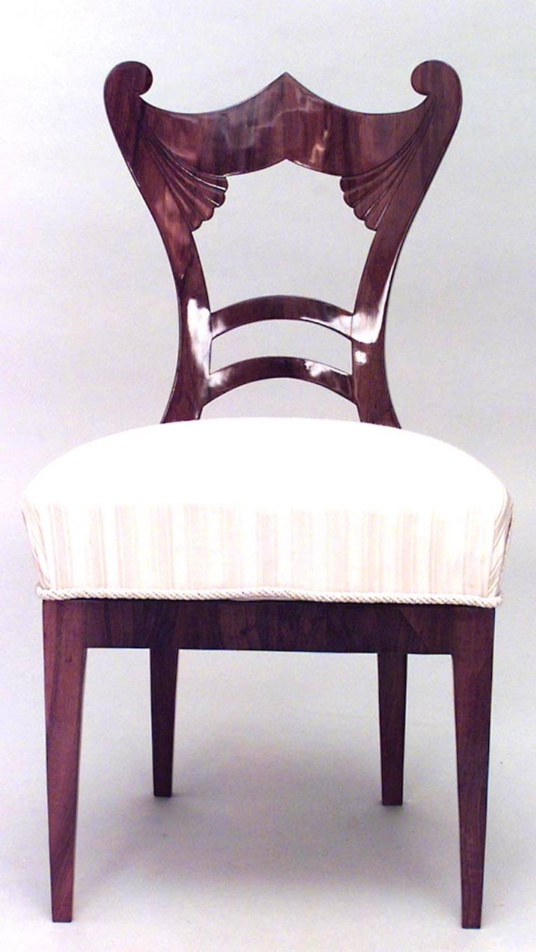 Pair of Austrian Biedermeier cherrywood side chairs with scroll and fluted design on back and upholstered seat, circa 1830.
 