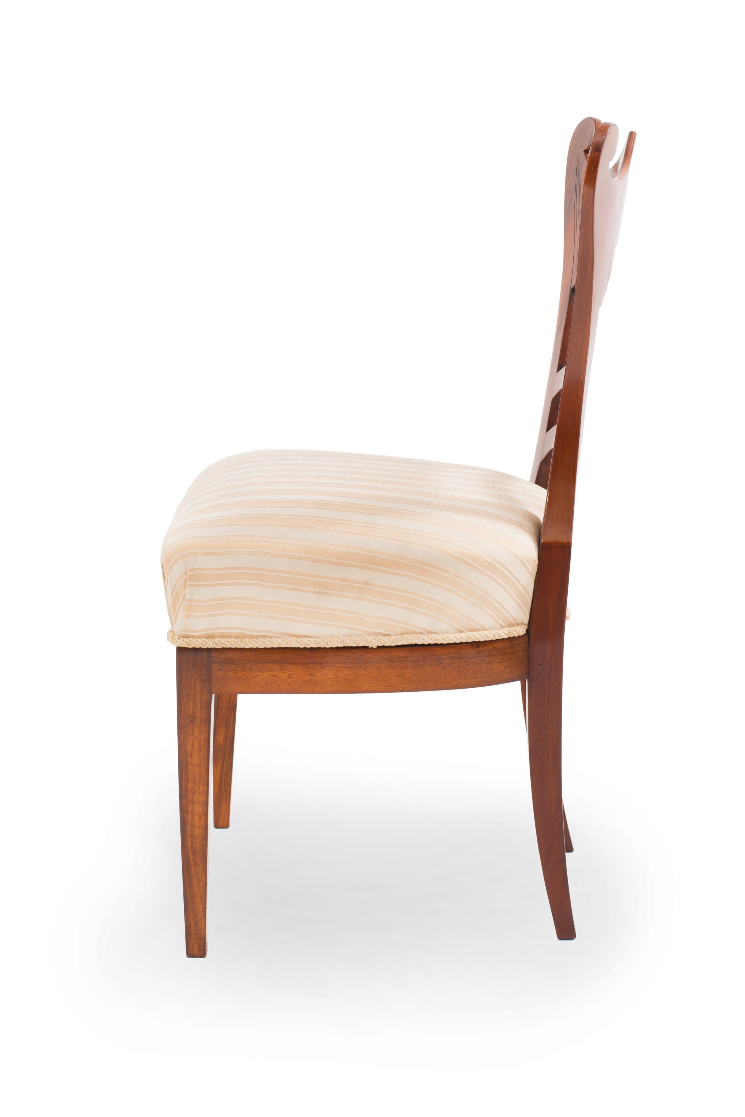 Pair of Austrian Biedermeier cherrywood side chairs with scroll and fluted design on back and upholstered seat. (Circa 1830)
