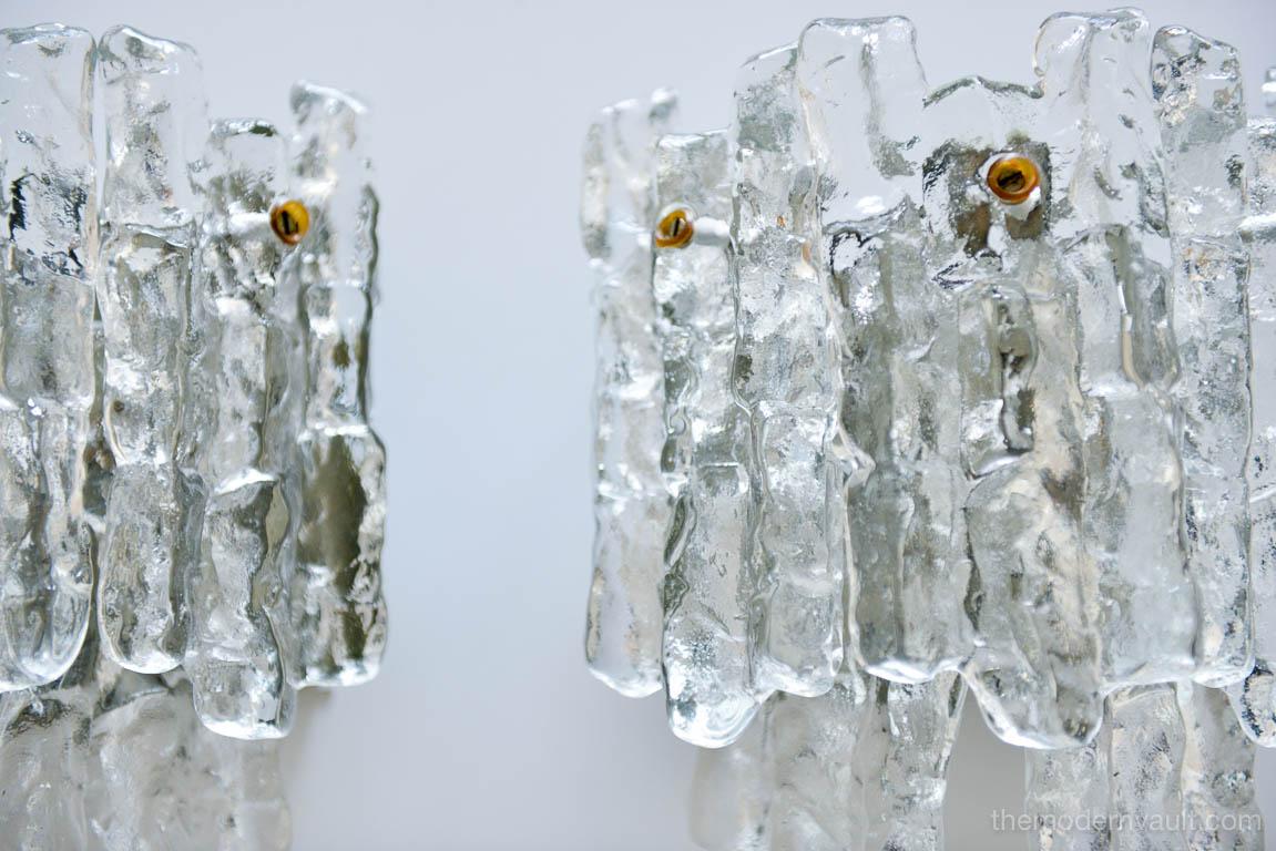 Pair of Austrian ice glass wall sconces by J.T. Kalmar, Austria, circa 1970. These are the larger 5 glass panel version with three 40W light sources with each sconce having five heavy pieces of ice glass in two tiers. Original wall mounting