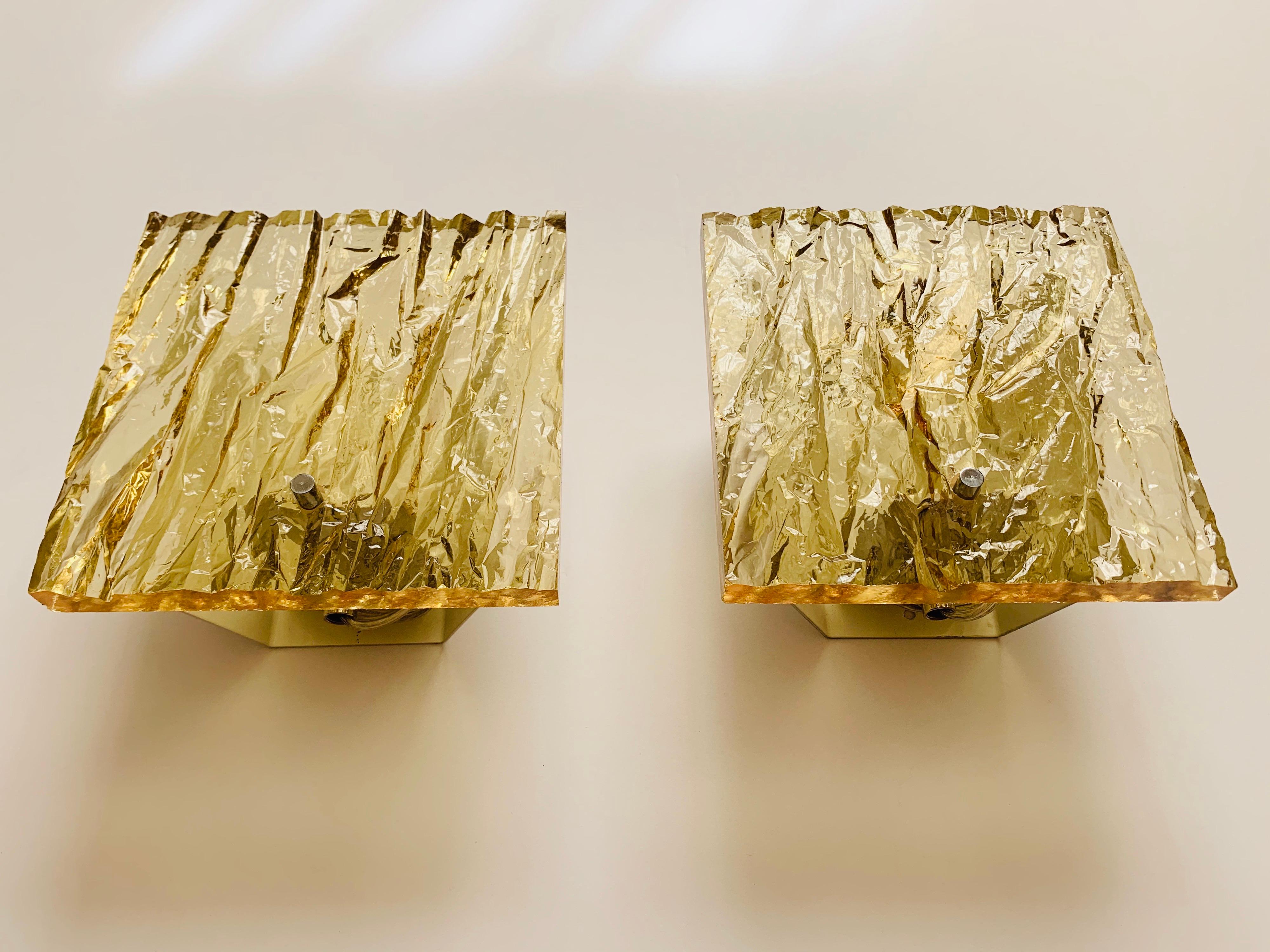 Pair of 1960s French sconces composed of thick textured Lucite shades made by Dallux and attributed to Serge Mouille.. Newly rewired.