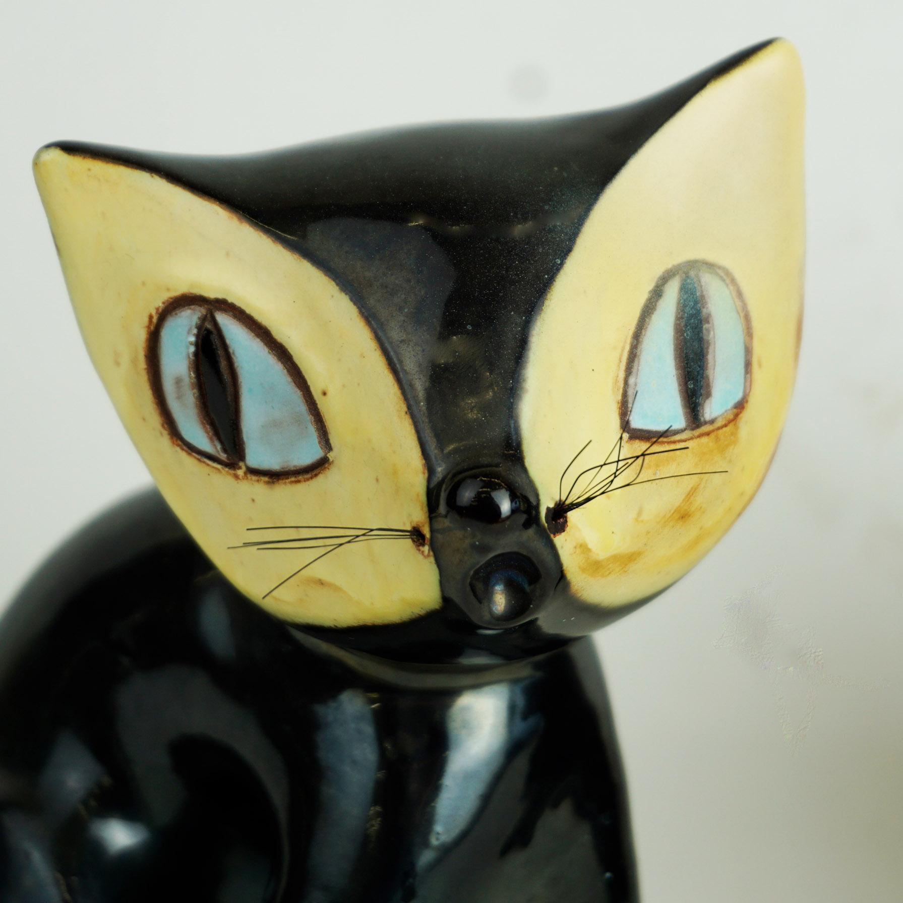 This charming humoristic cat sculptures have been designed and manufactured by the Viennese midcentury artist Leopold Anzengruber. Born in 1912 he founded his own company Anzengruber Keramik Wien in 1949 where he created his rich oeuvre, very well