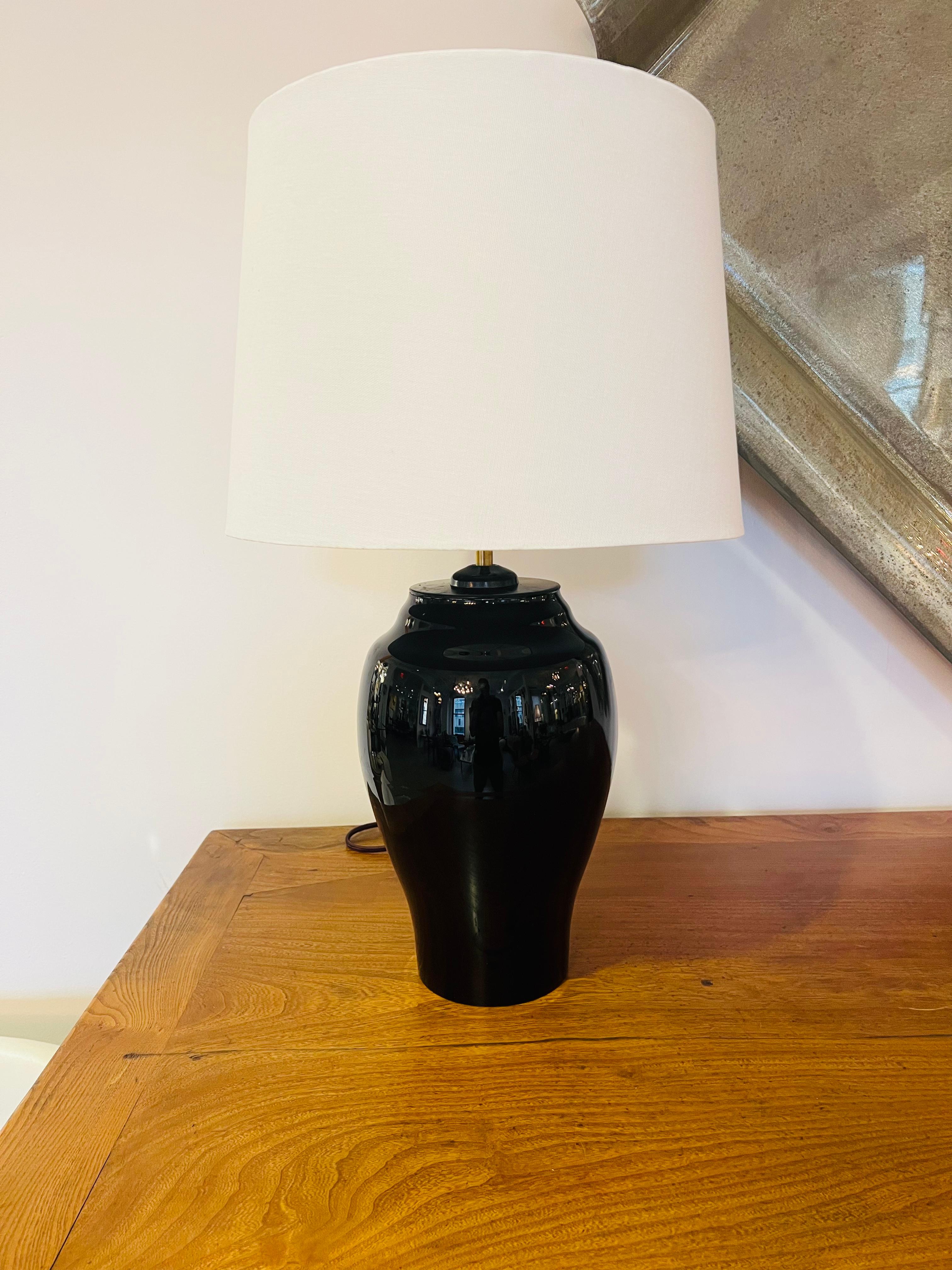 Pair of 1970s Austrian black urn crystal table lamps by famed maker, Moser. Rewired with polished double cluster brass sockets and brown cloth cords.