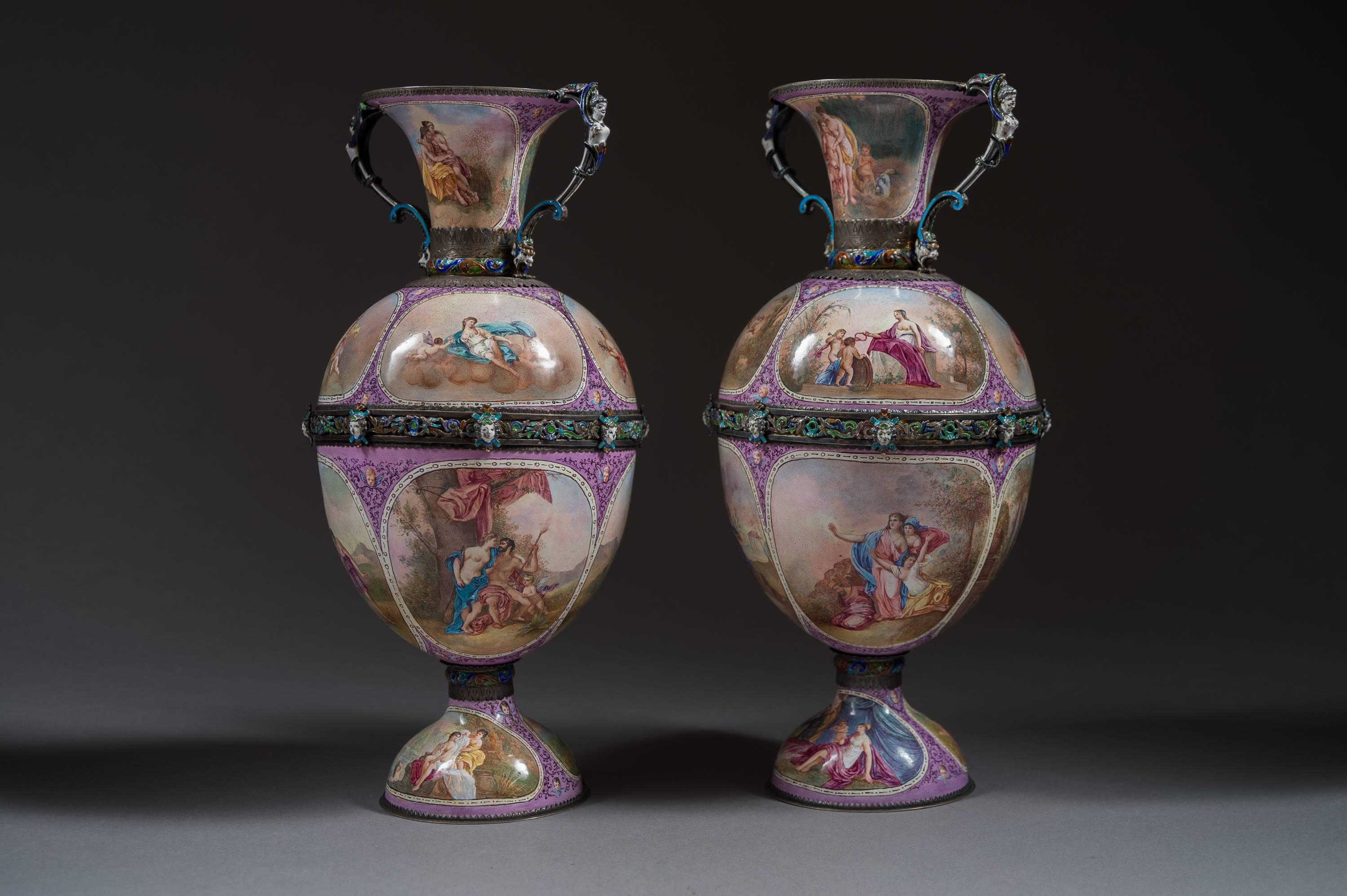 A pair of Austrian silver and painted enamel vases by Hermann Böhm, 

Austria, Vienna, circa 1880

Each with maiden handles, painted with classical medallions on pink ground base. With pierced, enameled masks and scrolls. 

Dimensions: Height