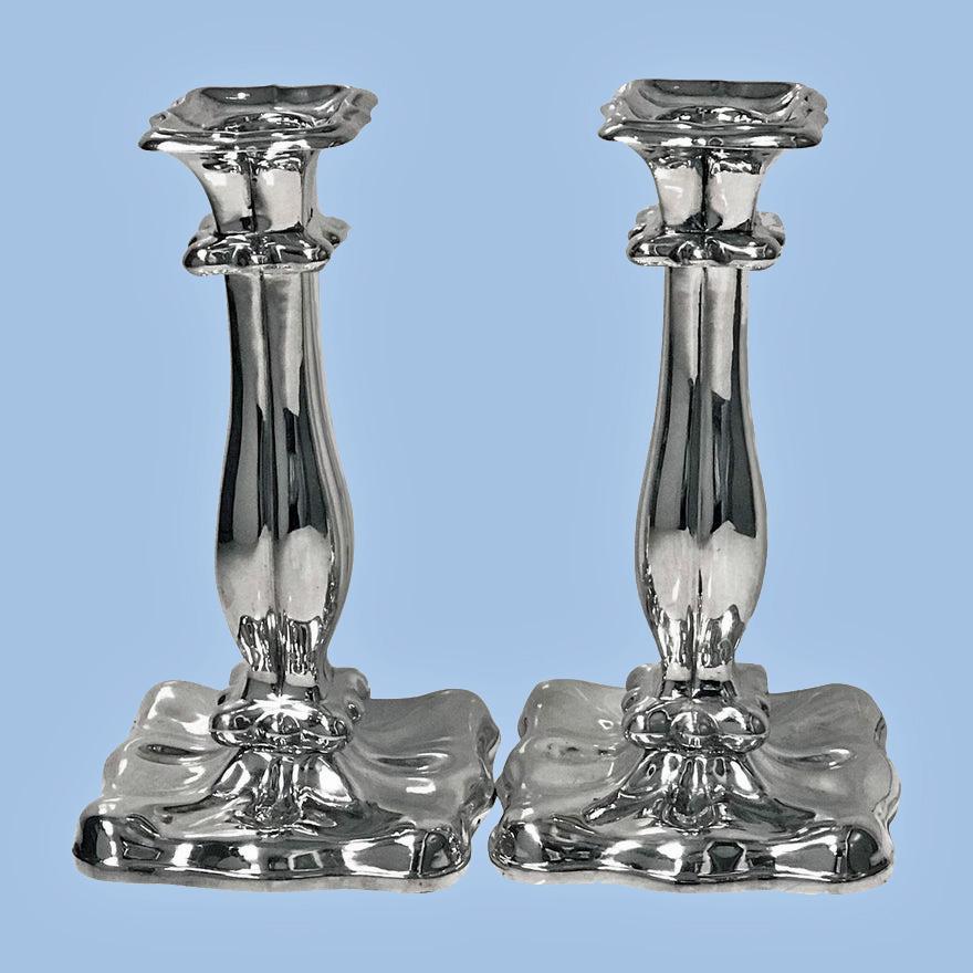 Pair of 19th century Austrian silver candlesticks, Vienna, 1840. Each on square lobate base, tapered baluster stems rising to conforming nozzles and drip pans. Marked under base with Austrian 13 loth mark for Vienna 1840 and maker's mark. Measures: