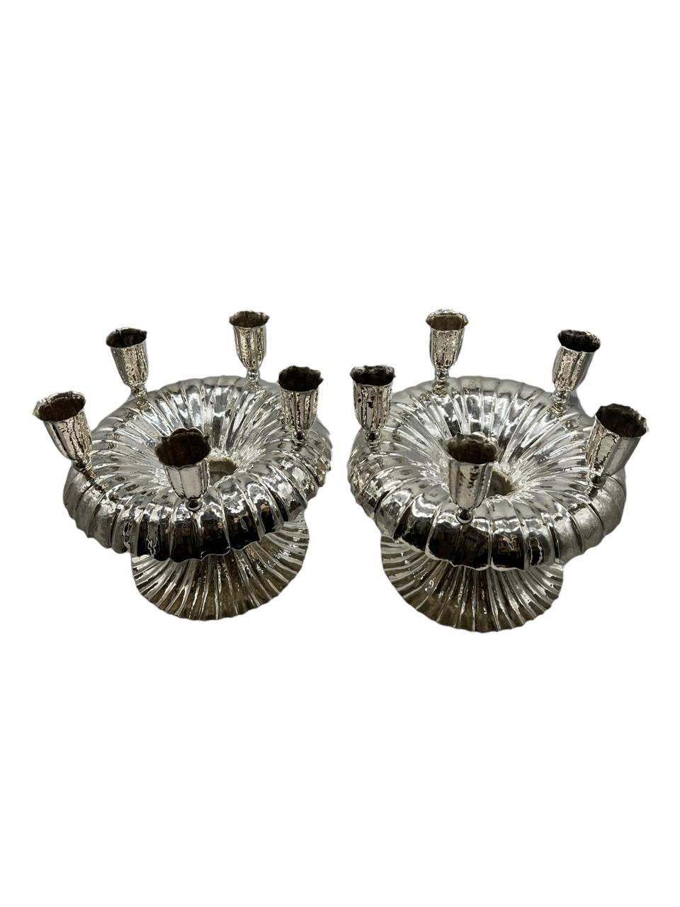 Circa 1925 pair of Austrian silver five-light candelabra by artist, Frank Brüder, From Vienna. Each circular with spot hammered surface, the lobed everted rim with scalloped edge and on a spreading circular foot, supporting five tulip-form sconces