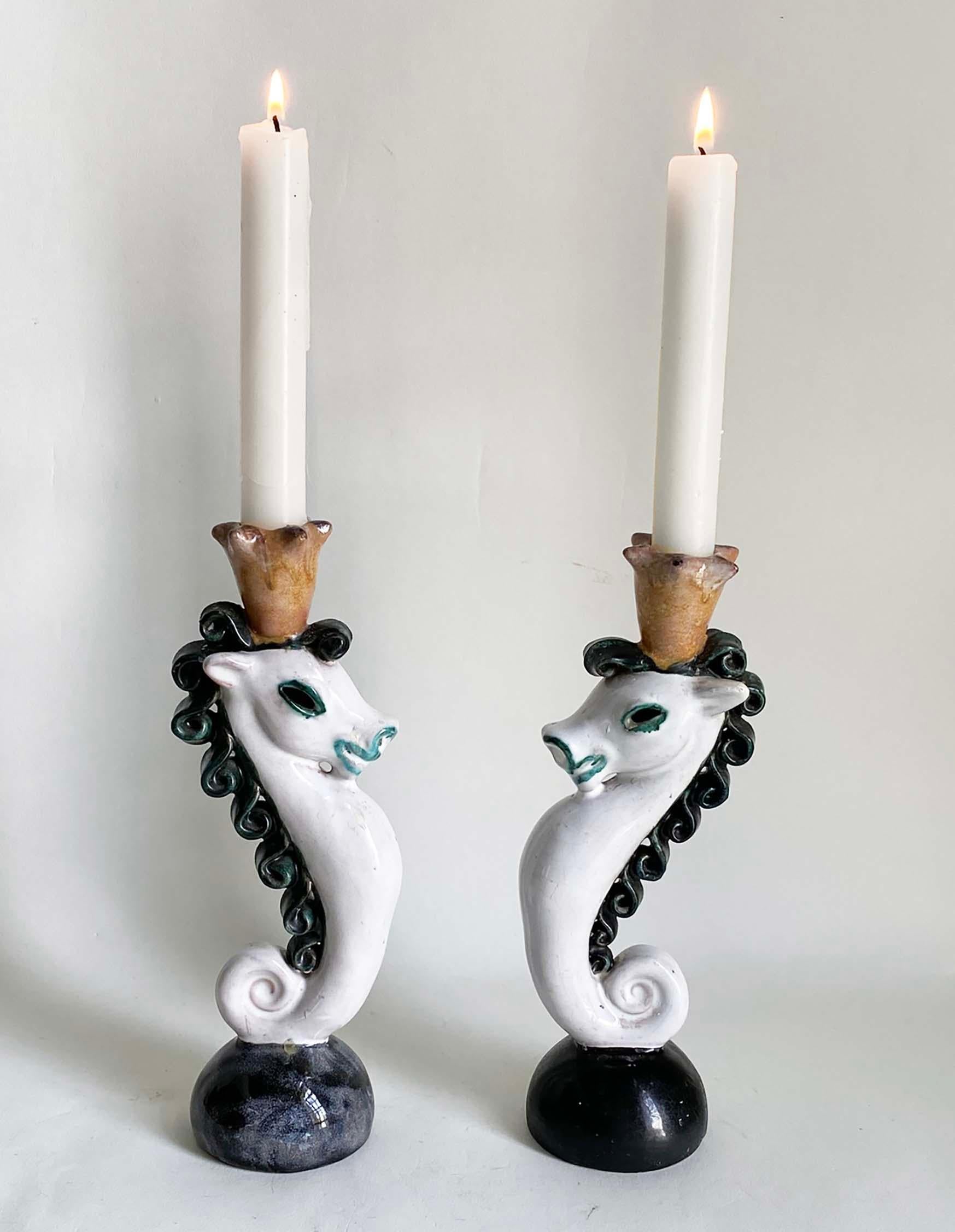 Here's a wonderful and whimsical pair of terracotta candlesticks made in Austria (signed) during the Wiener Werkstätte era. The design, clay and painting technique are very similar to the work of Kitty Rix and Vally Wieselthier, two of the great