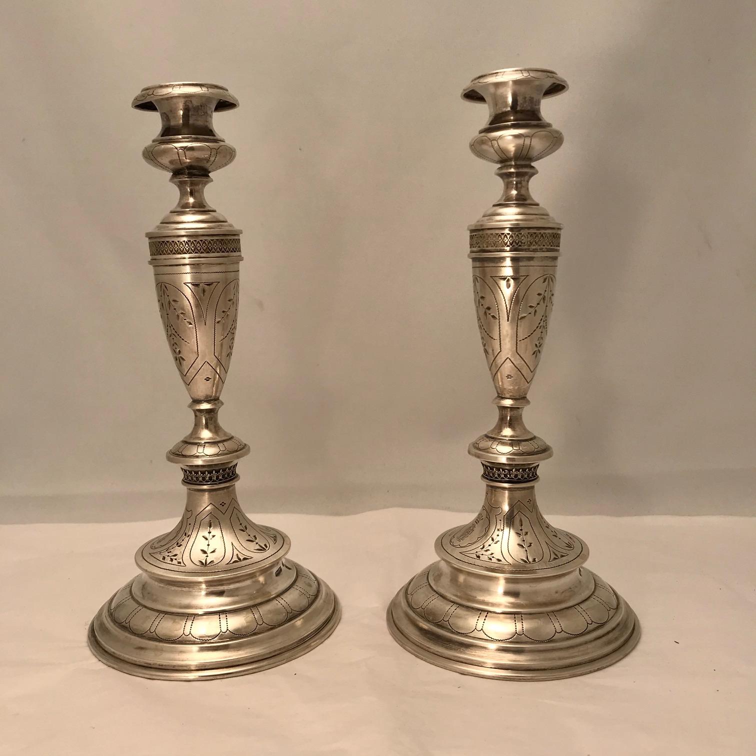 This pair are by Johan Schletter and have Austrian standard marks. They are bright cut with stylised leaves and with a noble crest in oval reserves, (a five pronged coronet with monogram). Judging by the style of decoration we think, circa 1880.