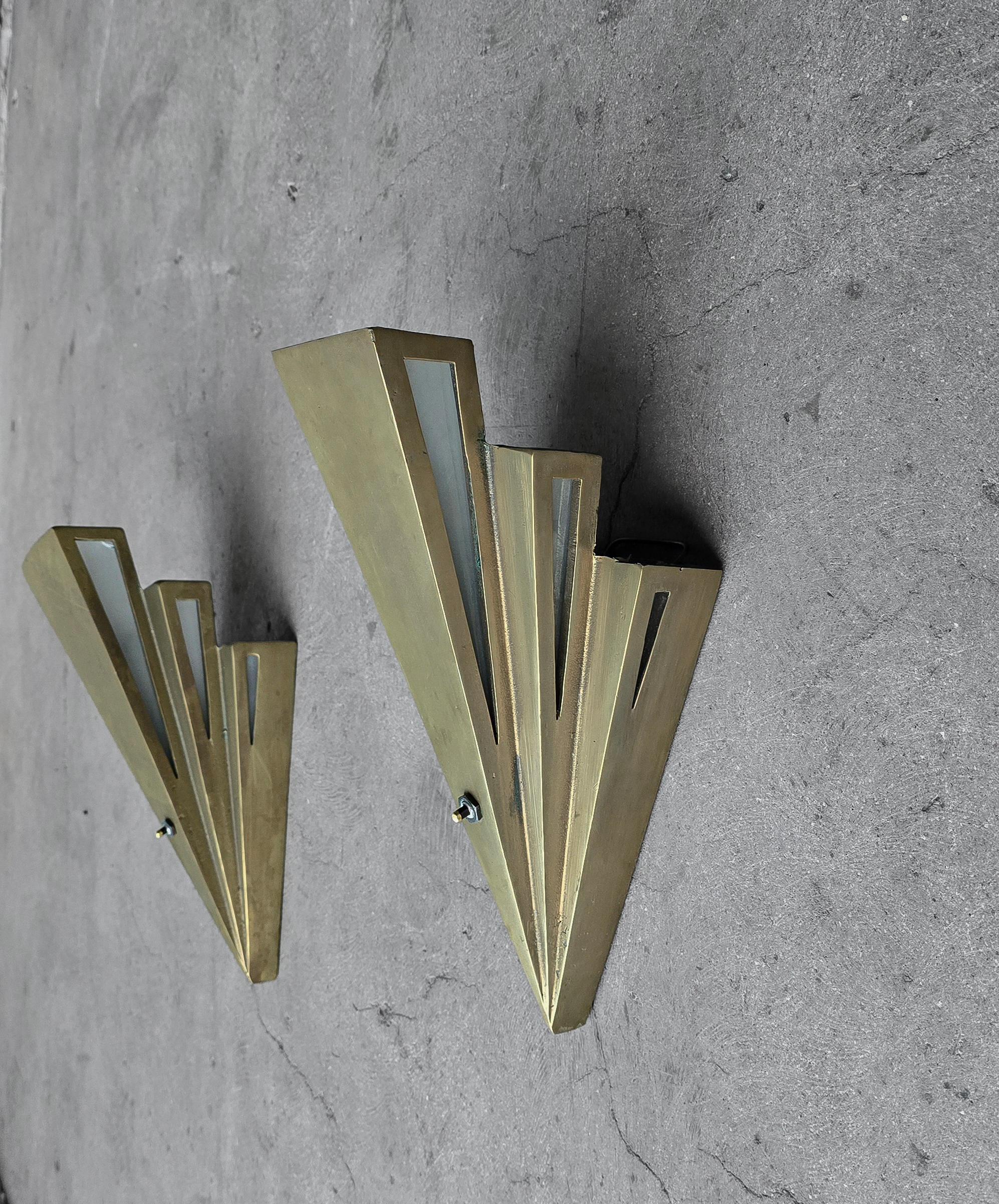 Paire d'appliques murales de gratte-ciel Art Déco AUTHENTIQUE absolument stupéfiante.  Les appliques sont en laiton massif coulé brut, très résistant, avec des panneaux latéraux en verre dépoli.

Si vous êtes à la recherche d'une paire de pièces