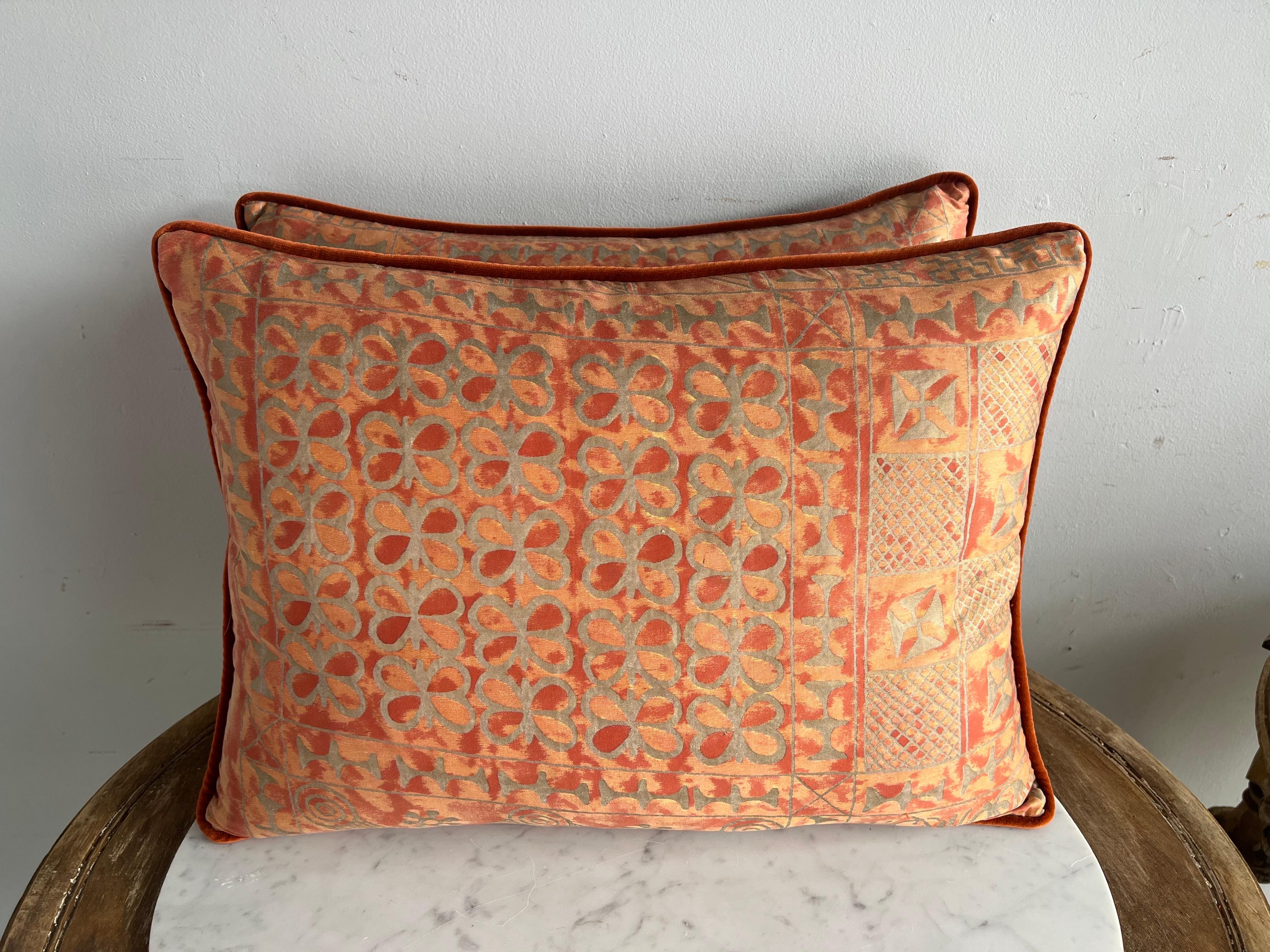 Pair of pillows made with vintage bittersweet and metallic gold Fortuny textile fronts and coral velvet backs. Self cord detail. Down inserts, sewn closed.