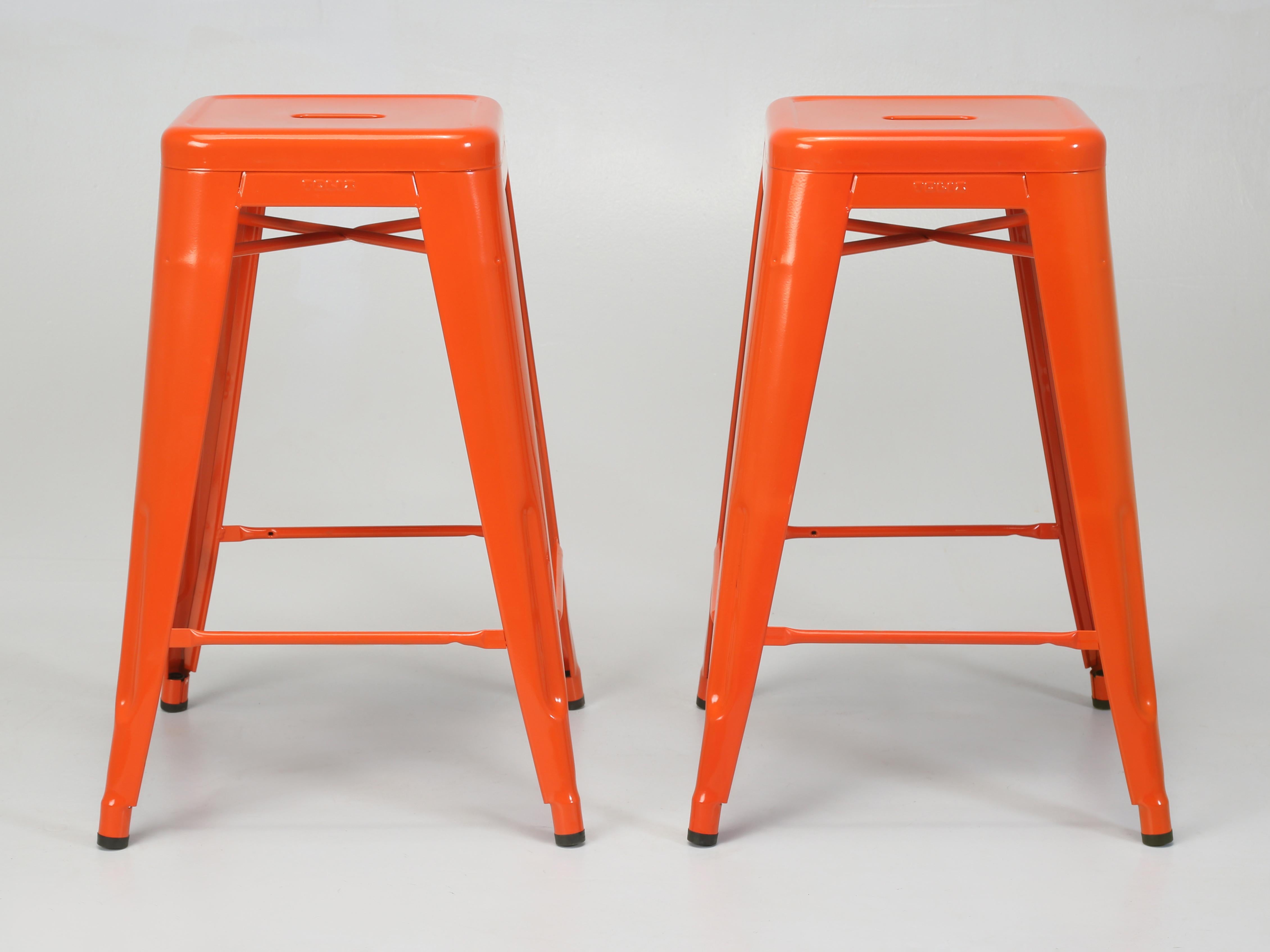 Authentic Tolix Steel Stacking Stools Hand-Made in France in a Set of 3 Orange Counter Height Stools. Old Plank has an additional 425-475 Tolix French Steel Stools available in standard counter height, 42