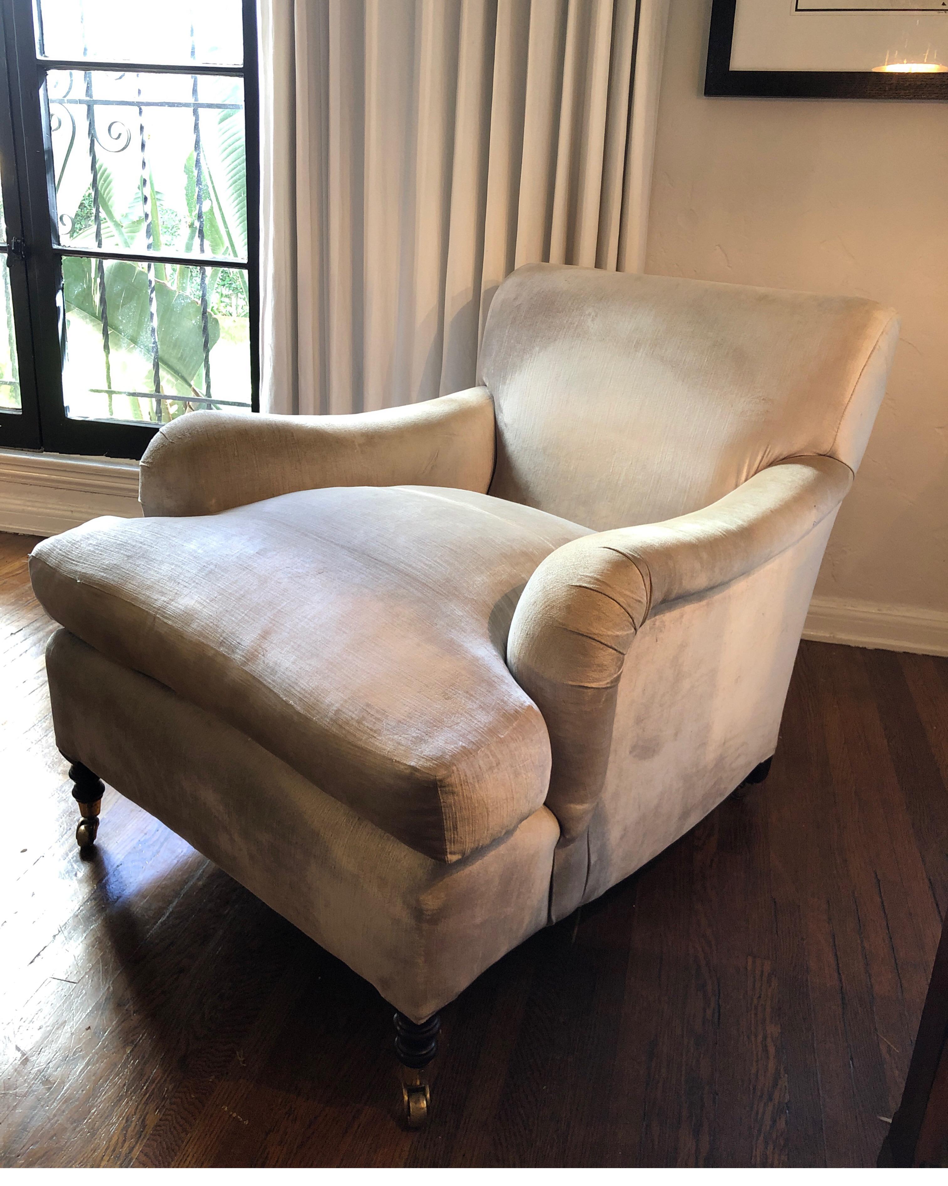 Pair of deep handmade George Smith standard arm chairs. Cushions are 100% down w/horse hair frame. Brass castors on front and rear. Chairs have a tight back to give a more modern/contemporary style.

Custom made in 1998 and shipped from England to