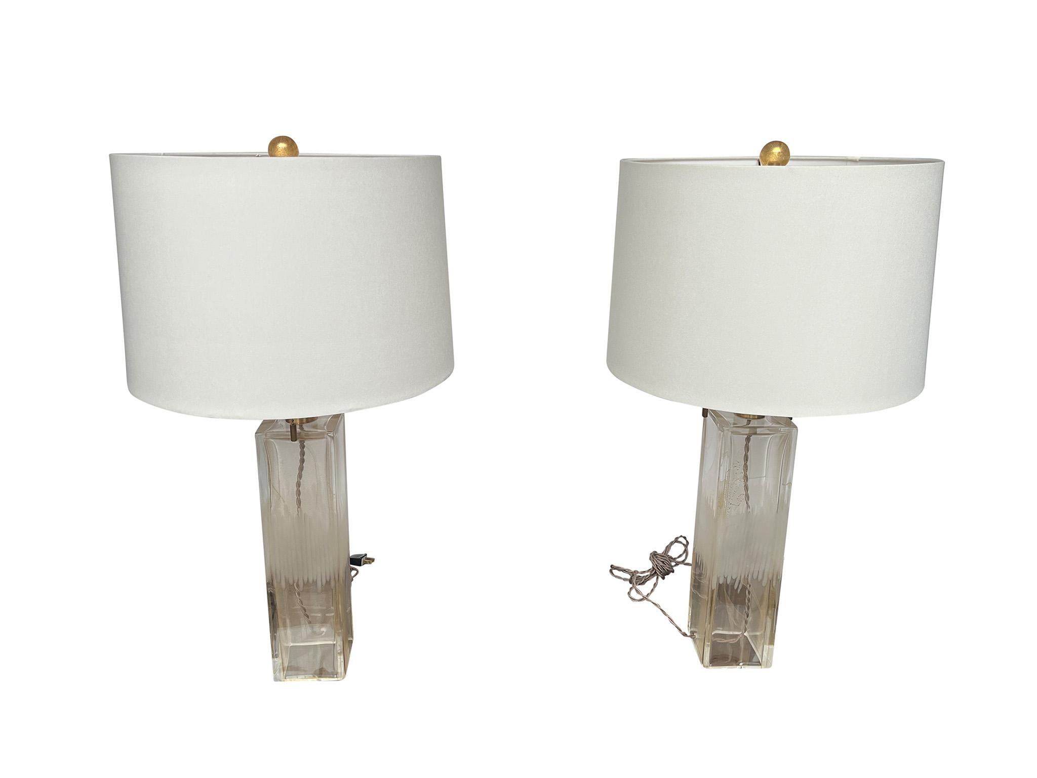 Luxurious pair of Aventurine glass table lamps by Donghia. Characterized by the delicate gold flecking that creates the aventurine effect and etched detail on the mid-body of the base, these lamps make a wonderful addition to any space. Signed