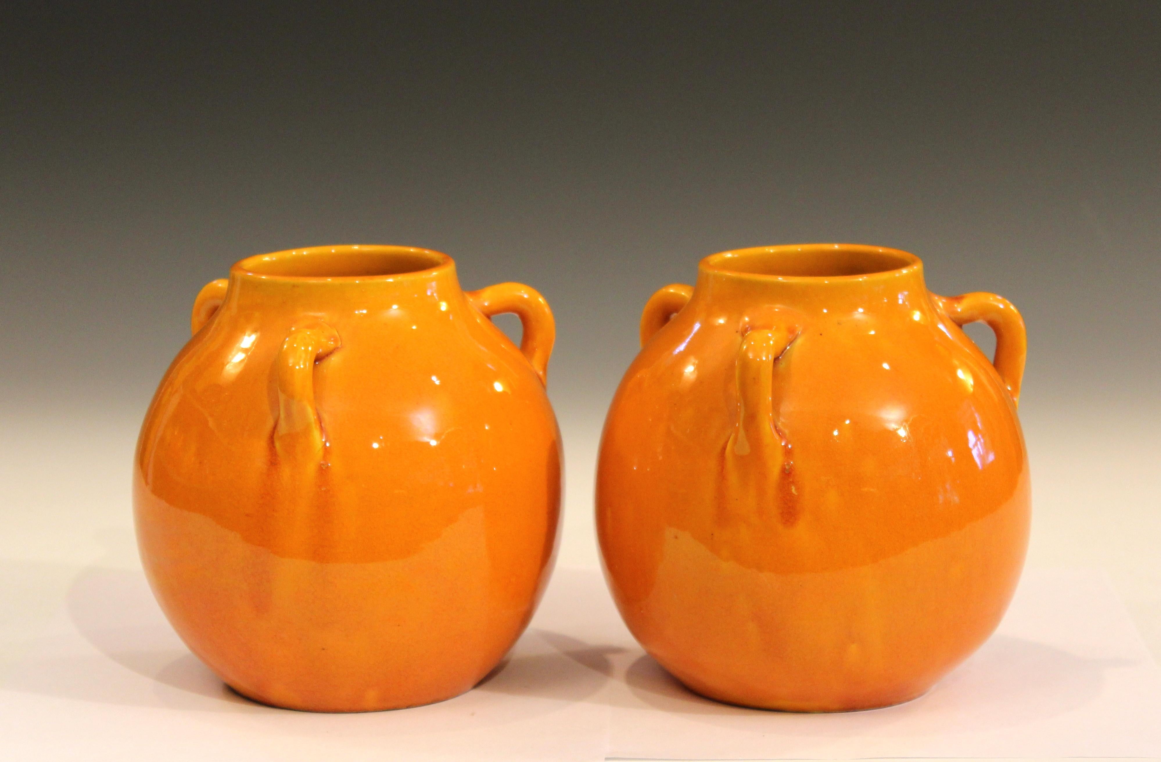 Pair of Awaji pottery vases in globular form with three handles and golden yellow crackle glaze, circa 1930s. Measures: 6