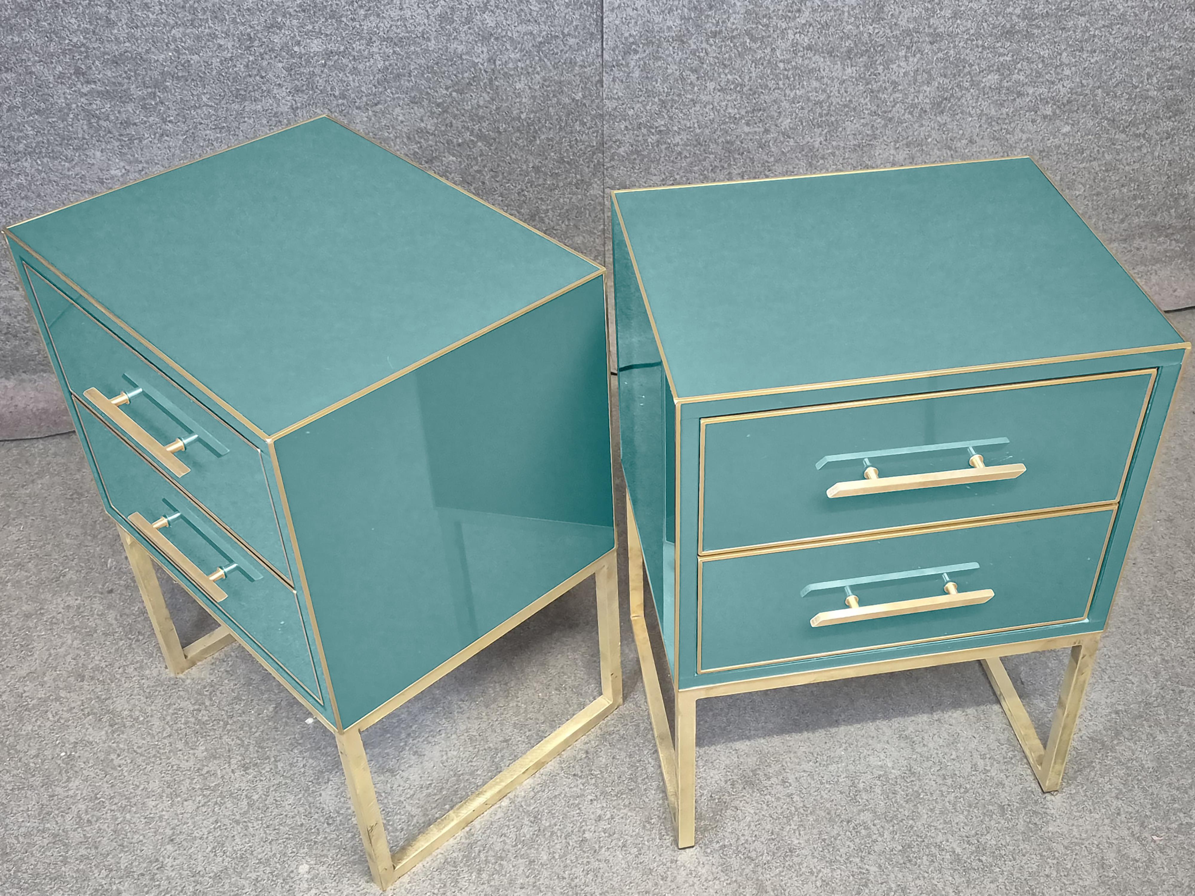 Pair of Azure bedside tables in solid wood and brass edging to bring mid-century modern style and Italian artistry to your bedroom.

Each bedside table features hand-carved and hand-finished details, with luxurious blue Murano glass surfaces and