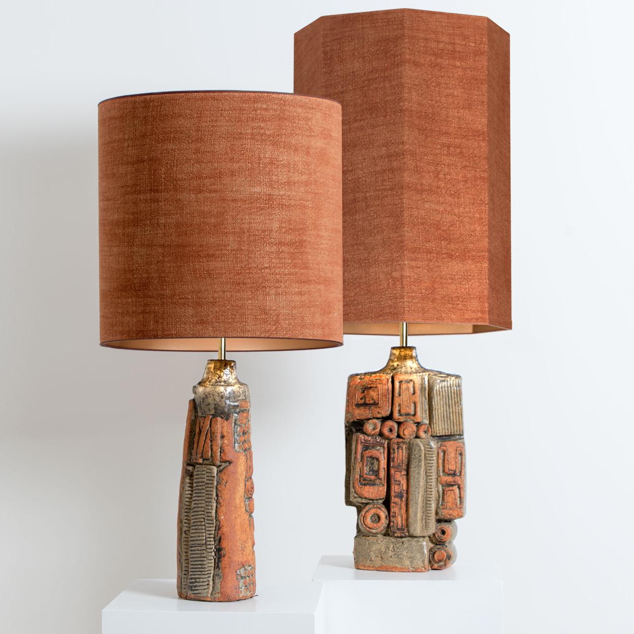 A rare pair of table lamps by Bernard Rooke, England, 1960s. Sculptural pieces, made of handmade ceramic elements in natural tones of terracotta and stone. With matching custom made lamp shade by René Houben. With warm bronze inner-shades.

The