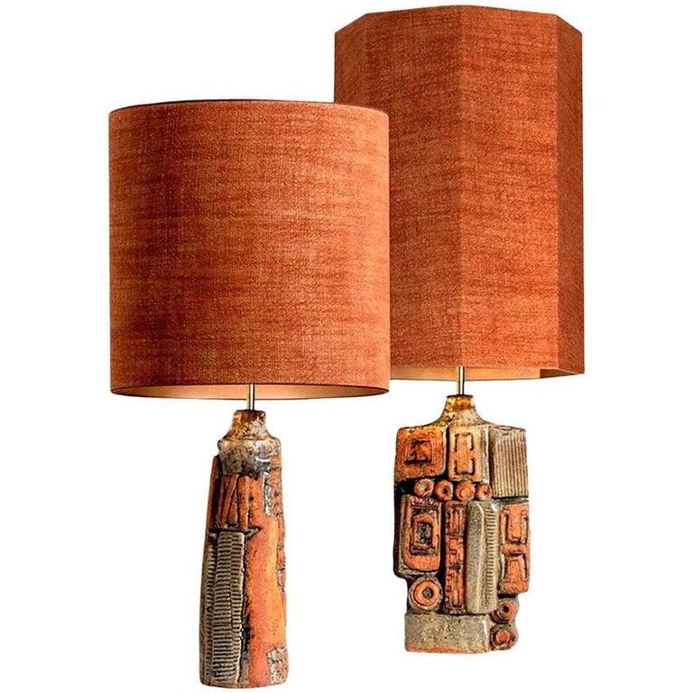 A rare pair of table lamps by Bernard Rooke, England, 1960s. Sculptural pieces, made of handmade ceramic elements in natural tones of terracotta and stone. With matching custom made lamp shade by René Houben. With warm bronze inner-shades.
The lamp