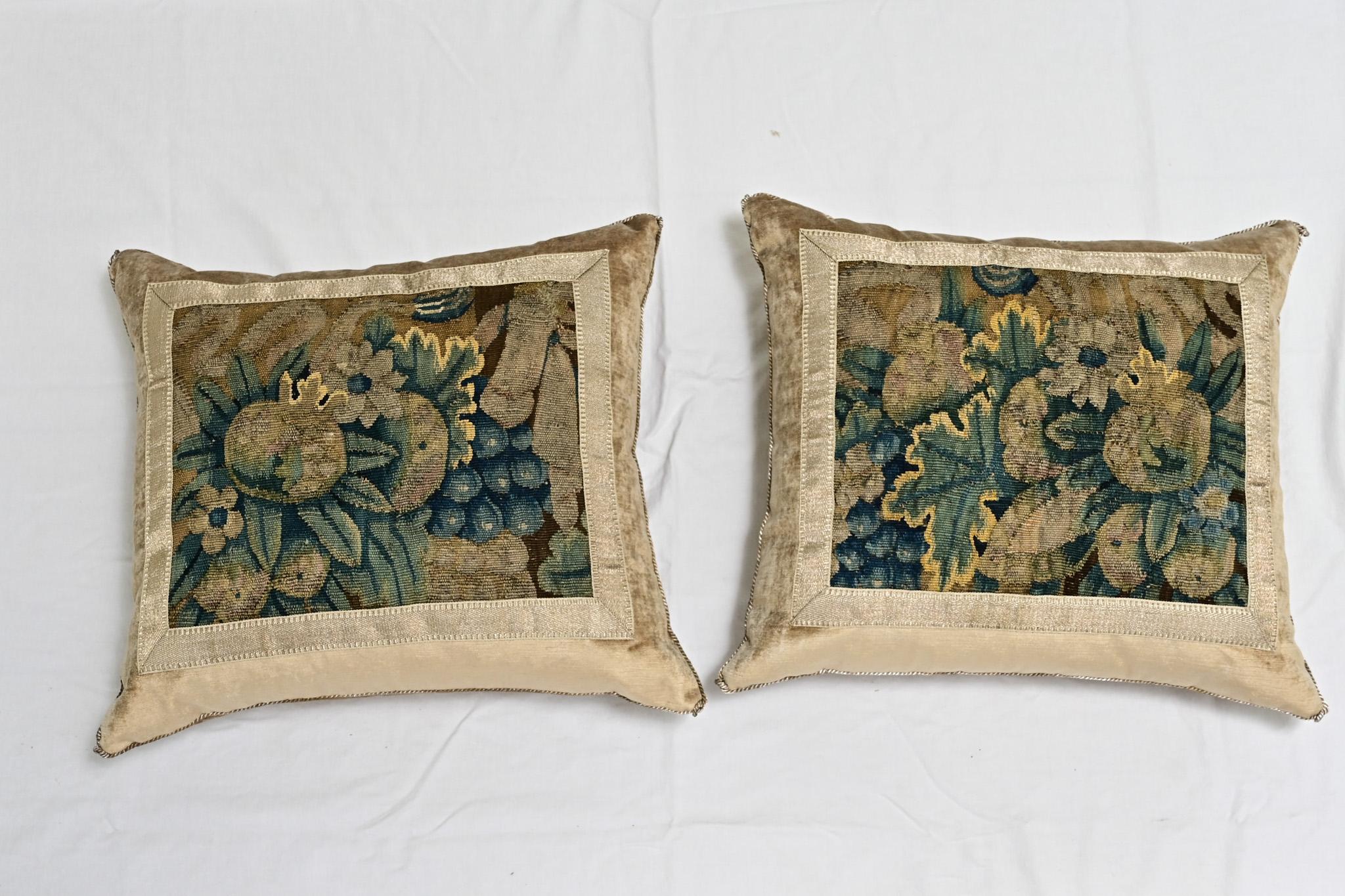 A pair of beautiful 17th Century Flemish tapestry fragment and velvet pillows. Hand trimmed and features vintage gold metallic cording, knotted in the corners. Designed by Rebecca Vizard for B. Viz Design. These down filled pillows make a statement