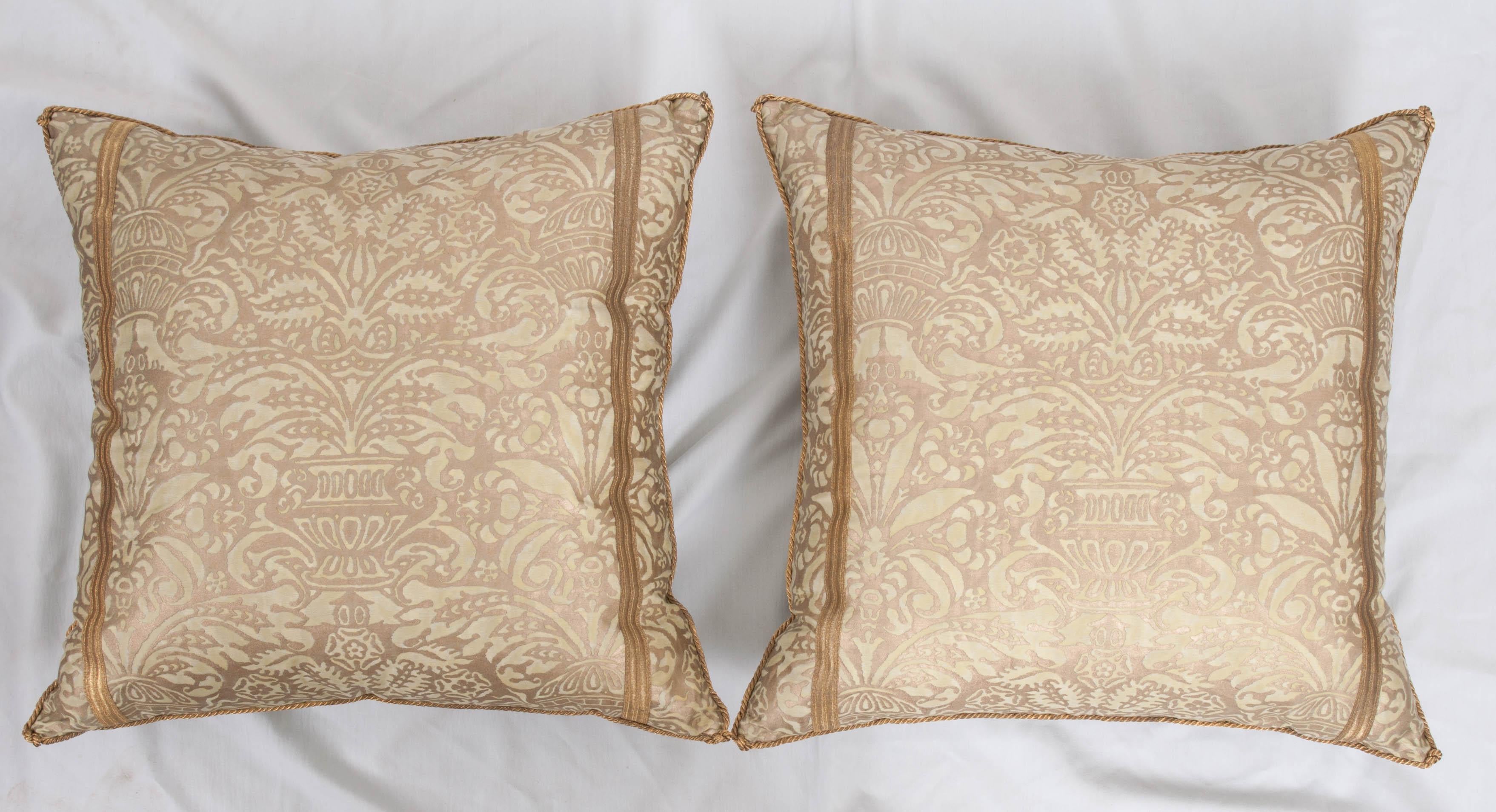 Pair of Campanelle Fortuny pillows in sea-foam green and gold, with two strips of antique gold metallic military trim and backed with pale pear-green velvet. Hand-trimmed with vintage gold metallic cording which is knotted in the corners.