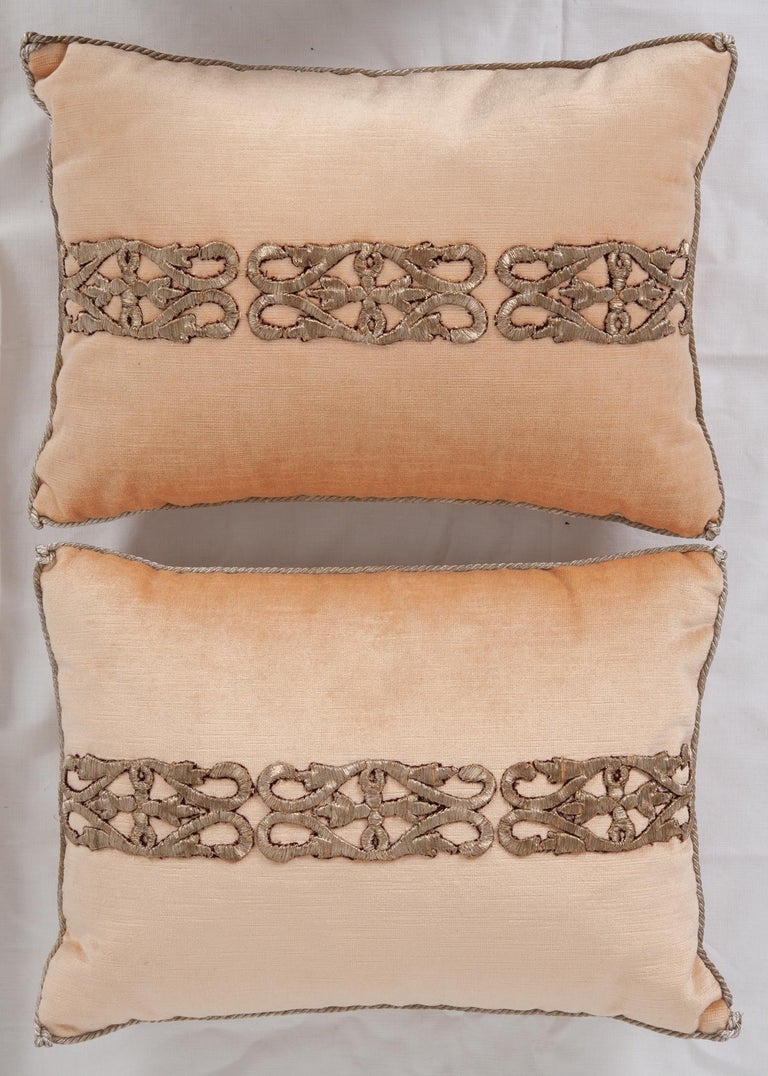 Antique Ottoman Empire raised silver- metallic embroidery on pale apricot velvet. Hand trimmed with vintage silver metallic cording, knotted at the corners. Filled with down feathers to help keep the structure of the pillow. These pillows are one of