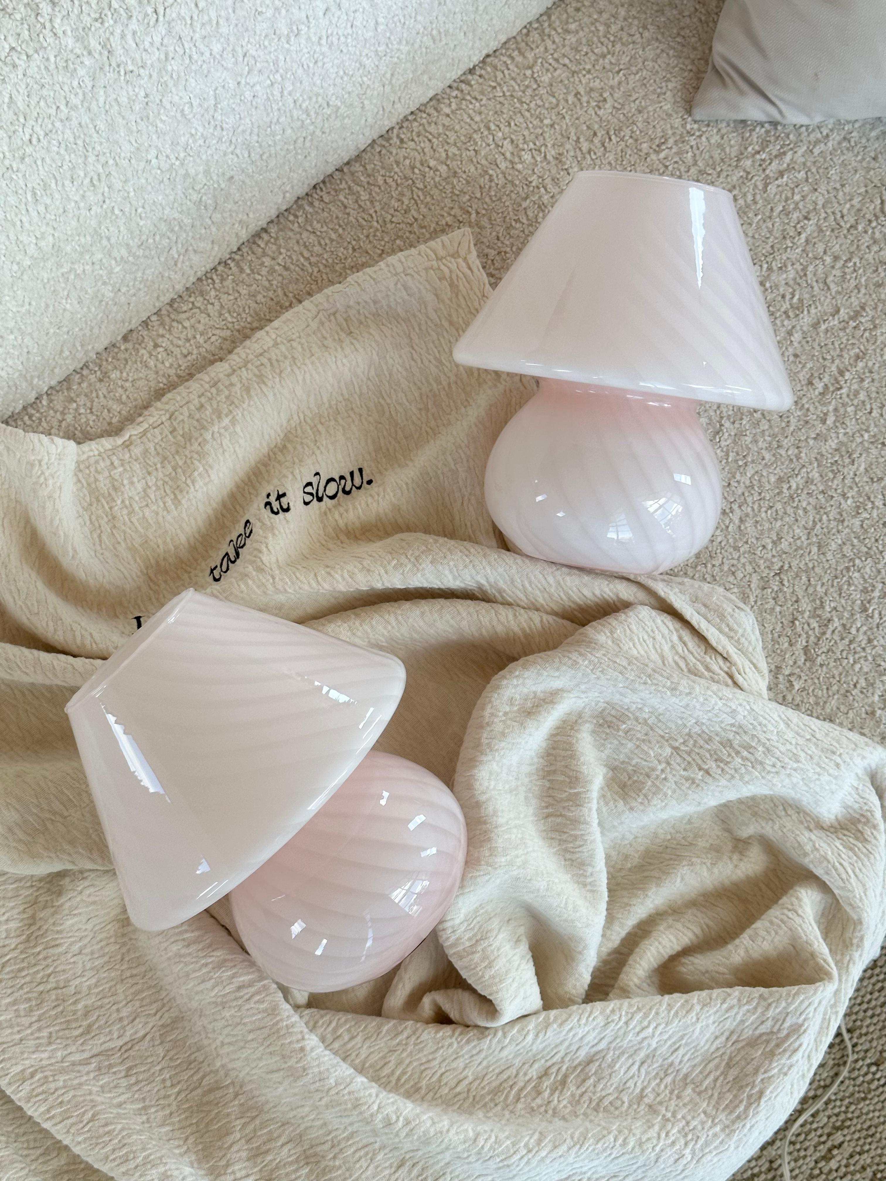 These baby pink Murano mushroom lamps are a stunning addition to any room. Each lamp is carefully handcrafted by skilled artisans using traditional Murano glassblowing techniques, ensuring that every piece is unique and of the highest