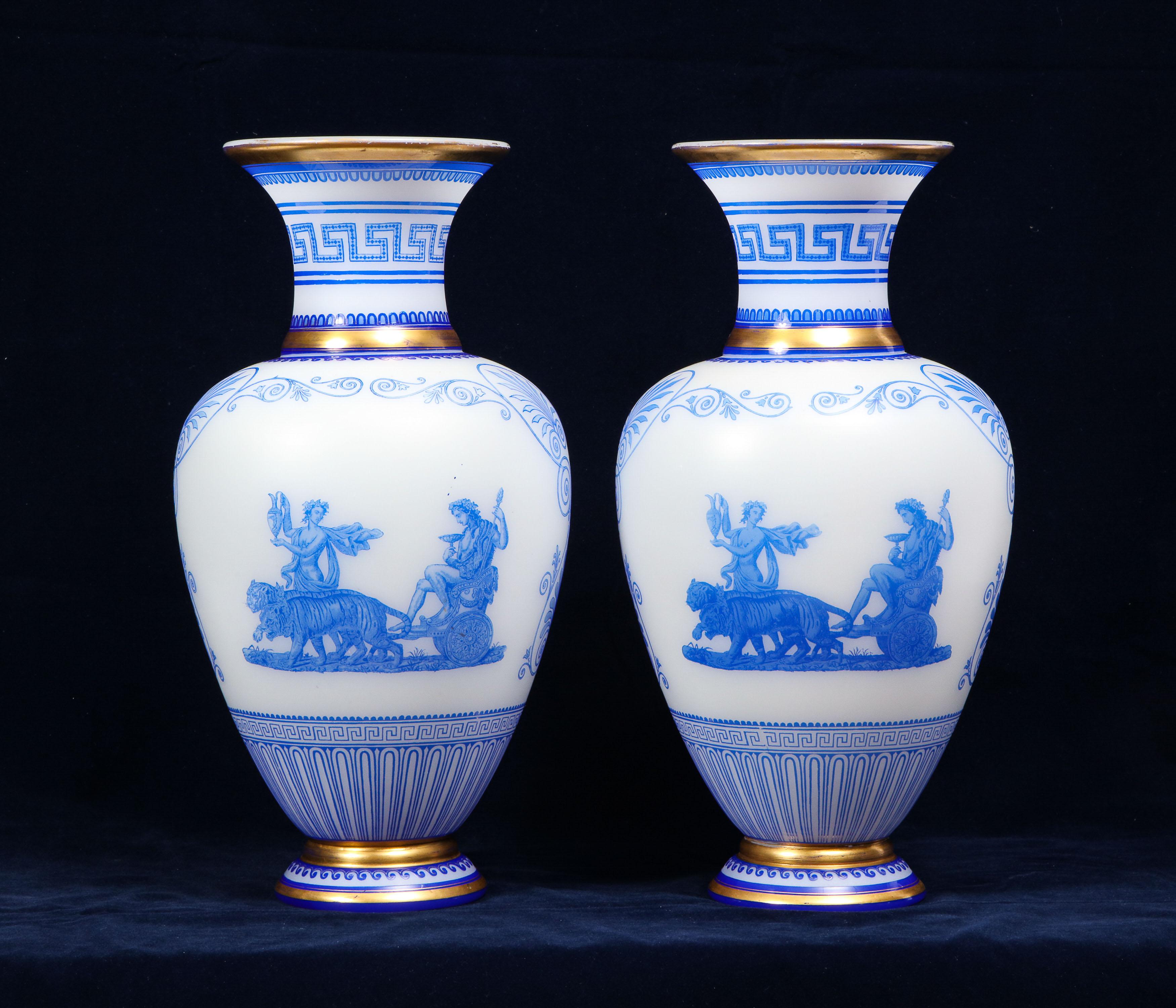 A fabulous & rare pair of baccarat acid-cameo double overlay blue-cased white opaline glass vases circa 1860-1870. Each vase decorated on the front and reverse with Bacchus or Ariadne in a chariot surrounded by scrolling foliage and anthemion