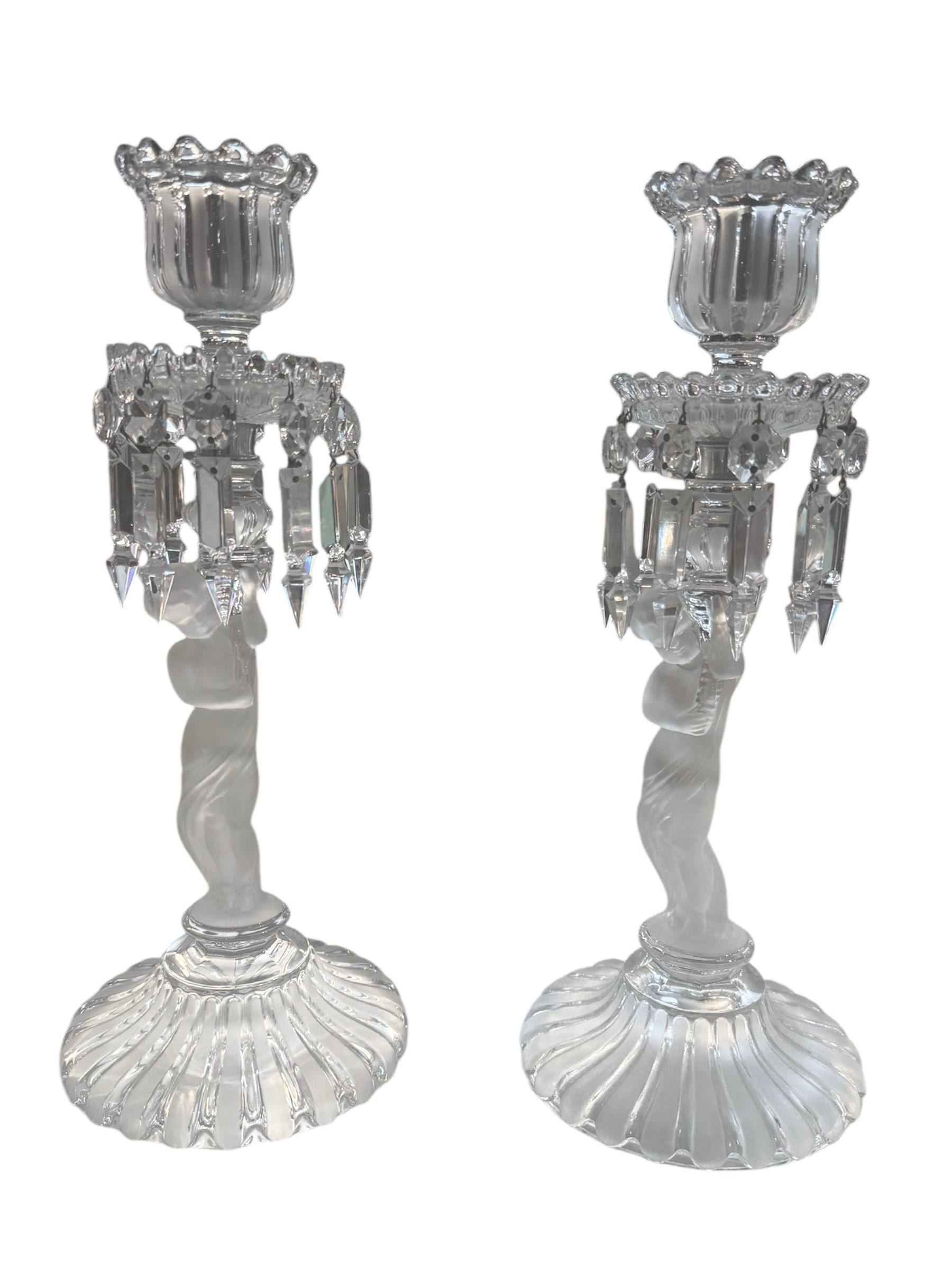 Each candlestick features a delicately sculpted 