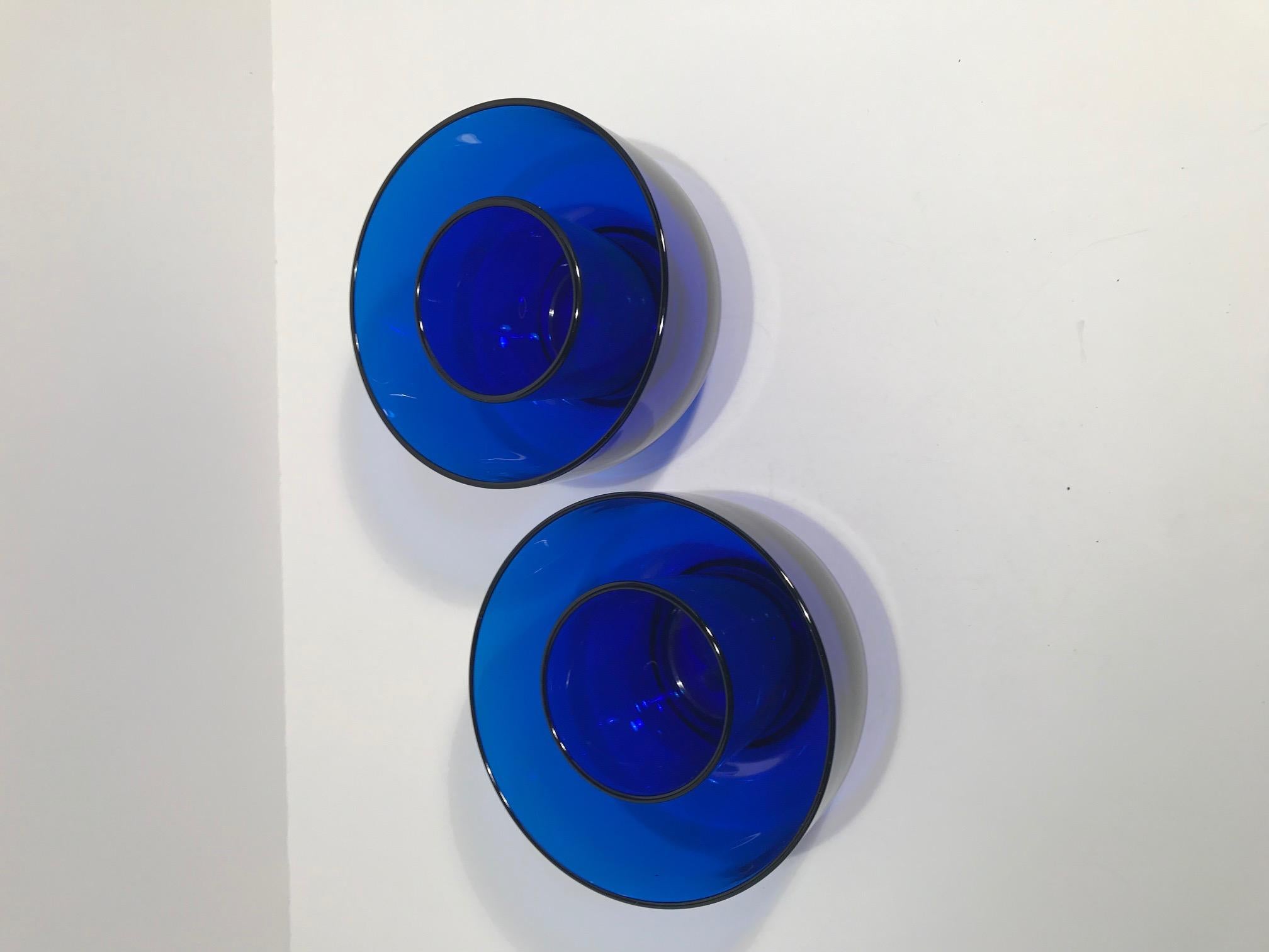 Pair of marked Baccarat cobalt blue chilling bowls. The pair of bowls was originally part of a set of twelve. I imagine the bowl by itself was used as a finger bowl, however, by adding the insert you could turn this pair into a chiller. The bottoms
