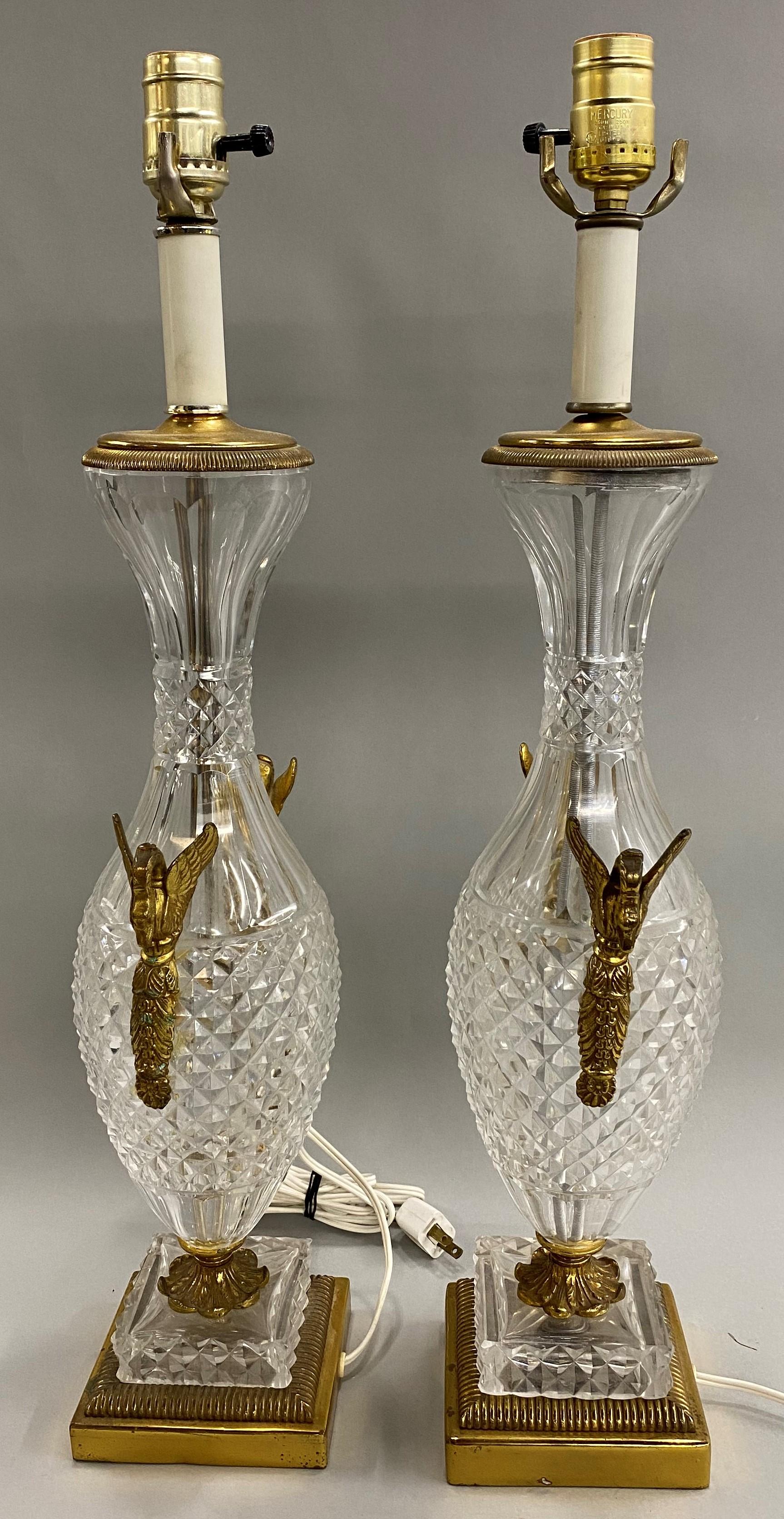 A beautiful pair of Baccarat crystal and gilt bronze table lamps, with applied swan ormolu, in good working order with new wiring, minor imperfections and light wear commensurate with age and use. The pair date to the 1930s and would make a fine