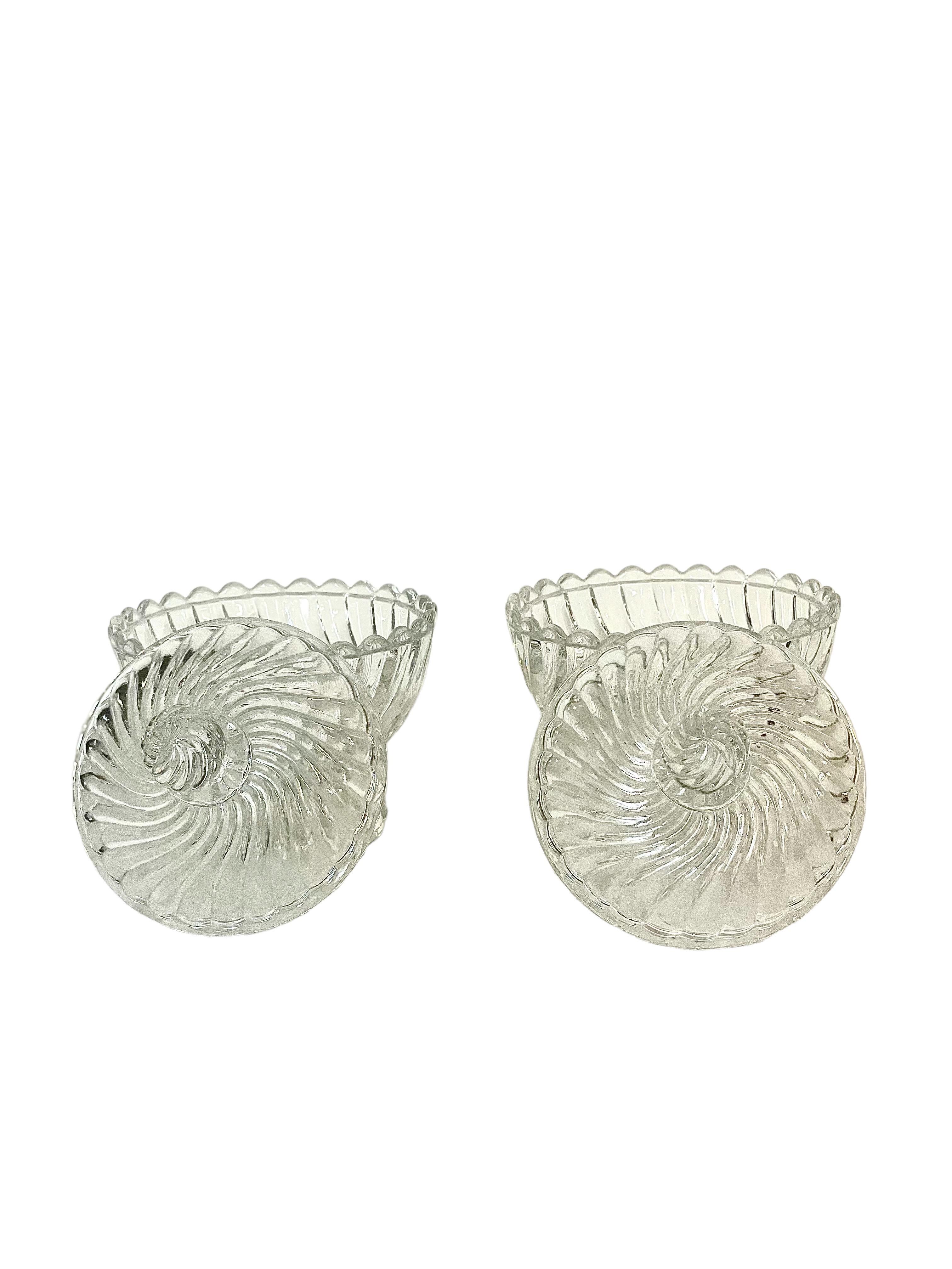 A charming pair of moulded crystal lidded bonbonnières (sweet dishes) or possibly sugar bowls, from the famous French crystal manufacturer Baccarat. Adorned all around the bodies and stoppers with wonderful twisted gadroons, these early 20th century