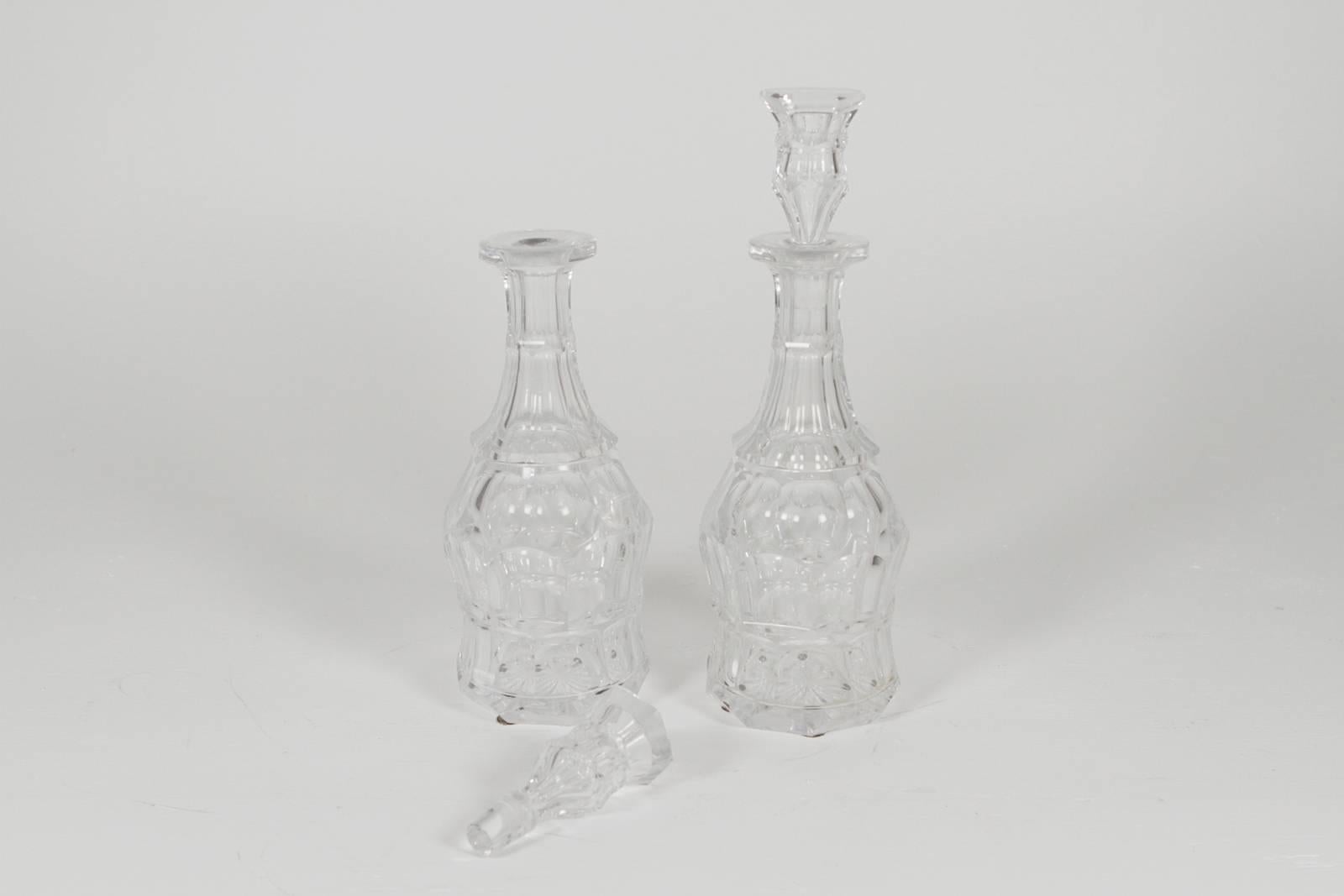 Pair of Baccarat crystal liquor decanters. Exquisite panel cut sides in water clear crystal with original stoppers.