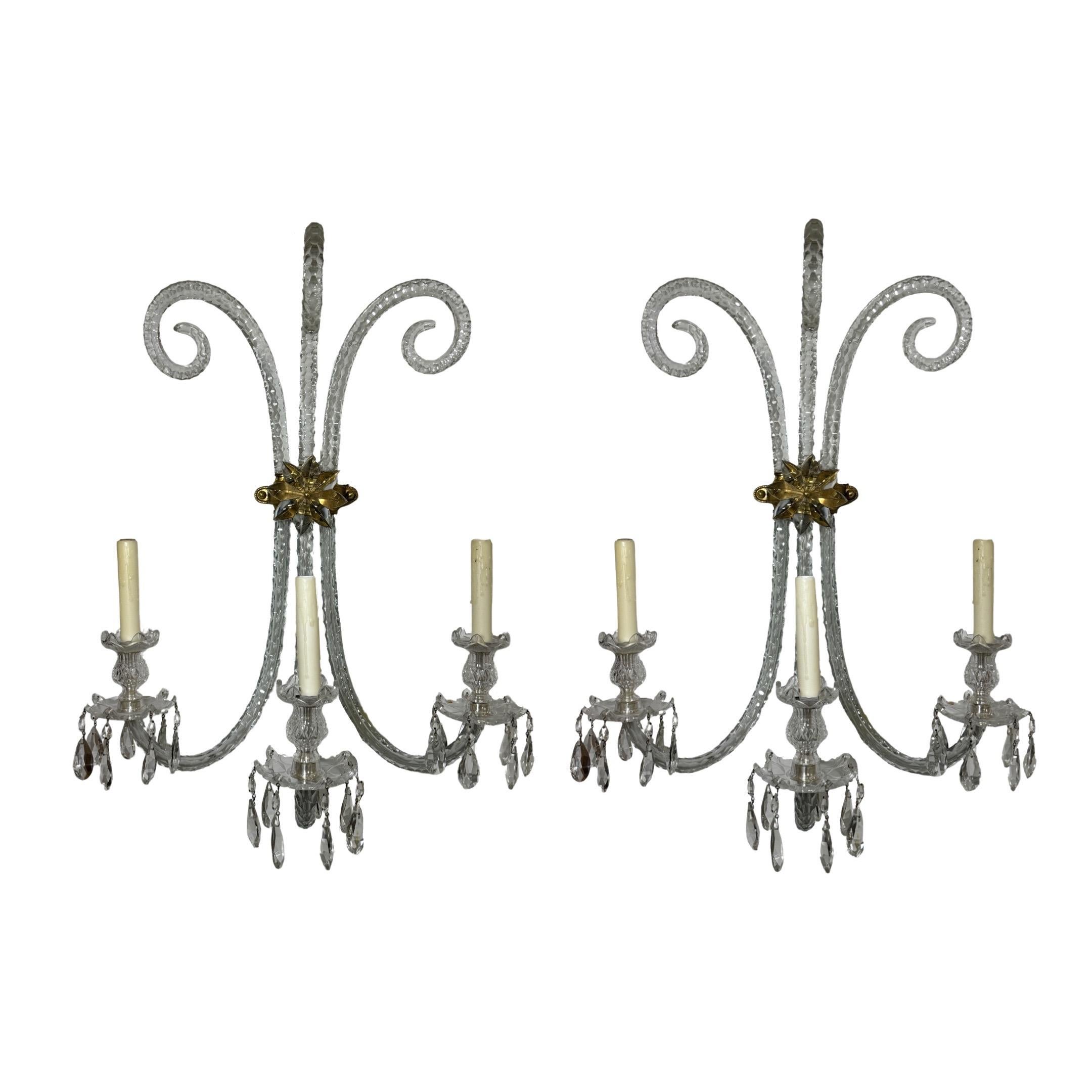 This stunning pair of Baccarat crystal wall sconces will make a beautiful addition to any home. Expertly handcrafted in Italy in the 19th century, these light chandeliers feature baccarat crystal and bronze hardware. Enjoy the classic beauty of this