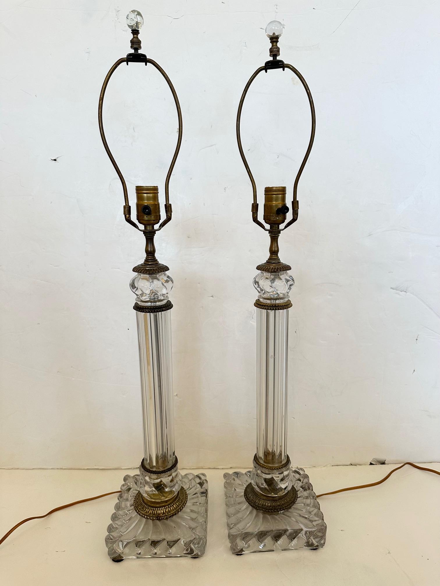 Classically elegant pair of handblown fluted glass columnar lamps by Baccarat with bronze mounts. 