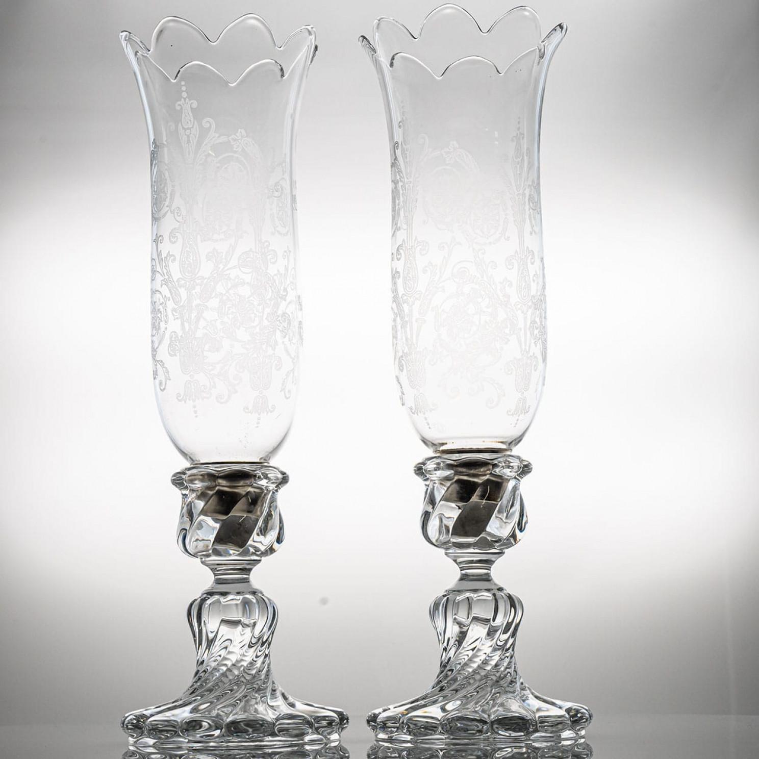 A set of two crystal masterpieces of beautiful proportions, these 2 vases crystallize the extraordinary know-how of the Baccarat craftsmen. The different cuts in the vases produce a magic visual effect and with the engraved flowers this set is a